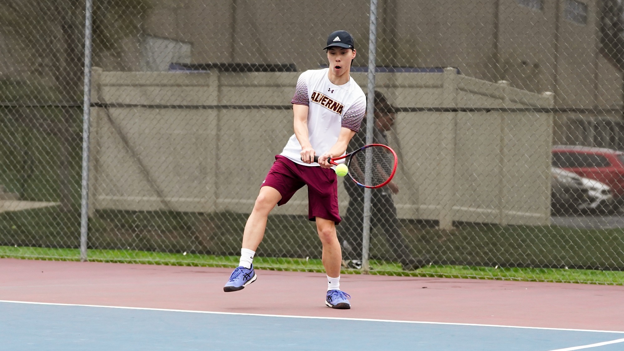 Andrew Kao returns a serve