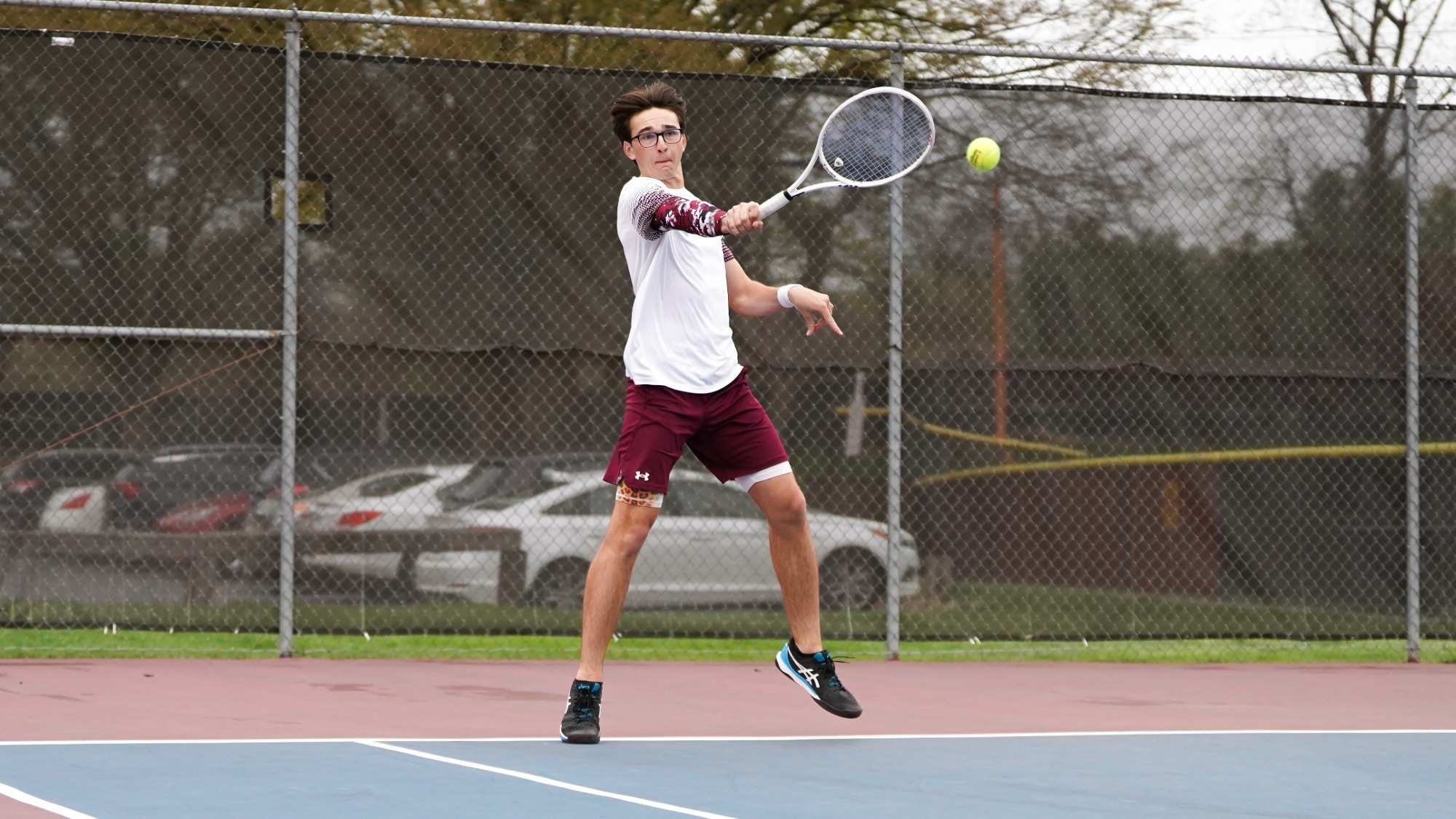 Luke Brisbois returns a serve