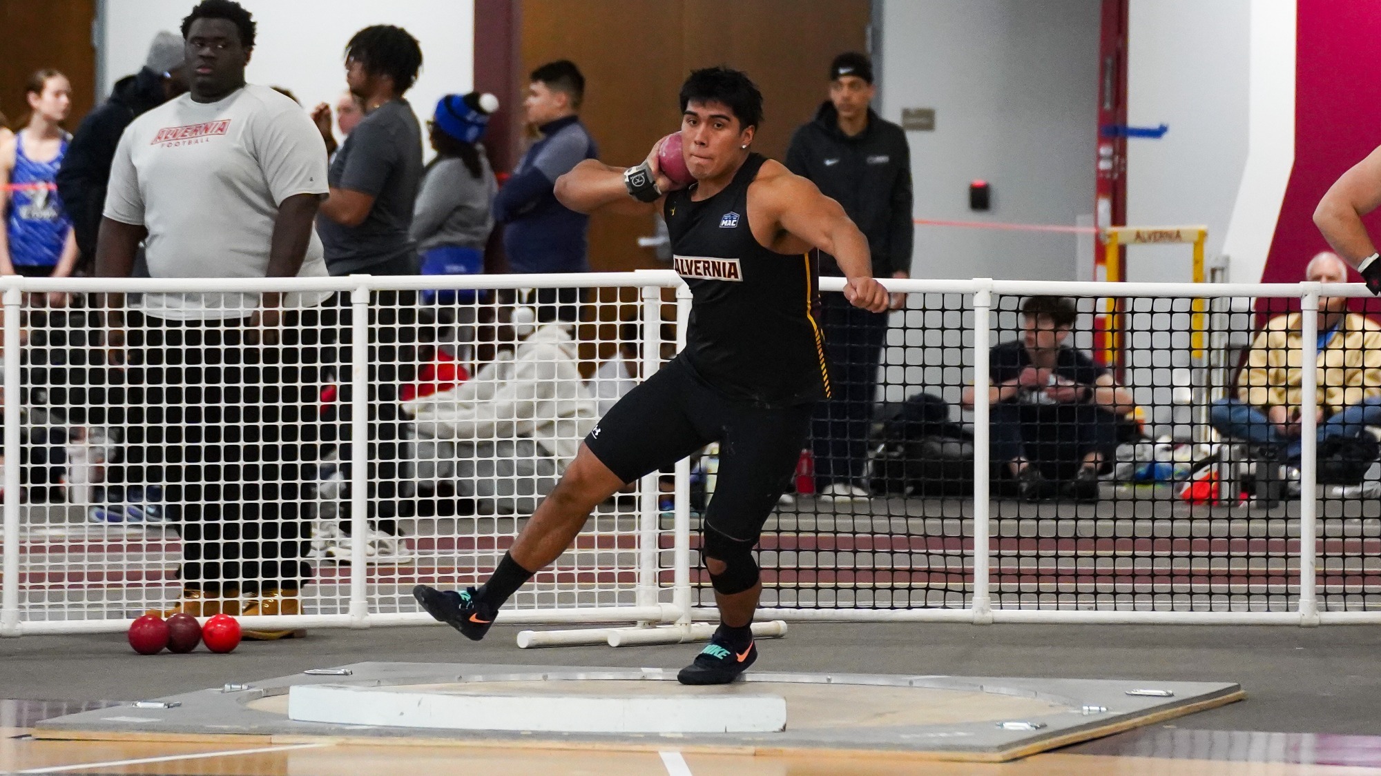 Christian Medina throws the shot put