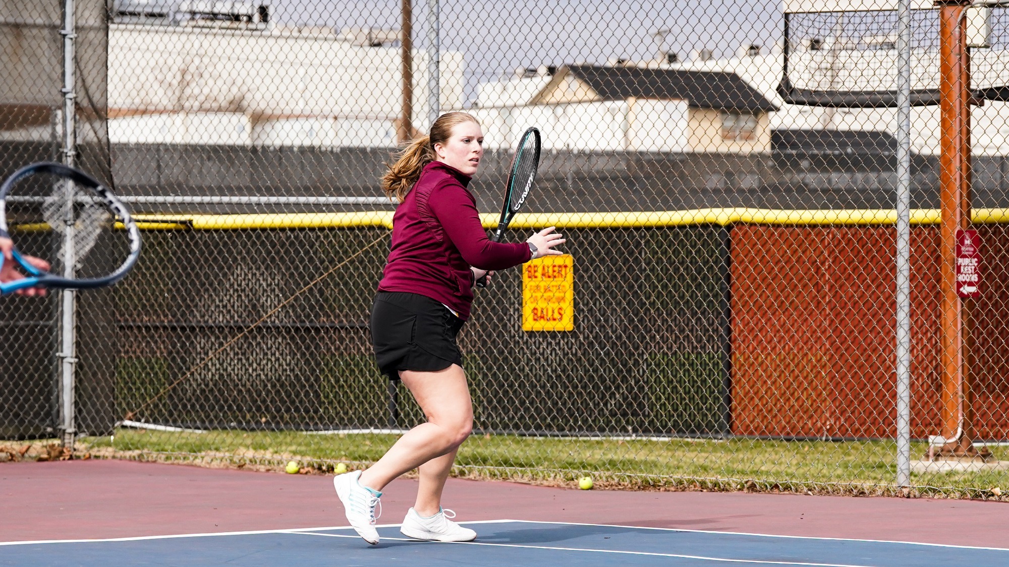 Jillian Laughman returns a serve against her opponent