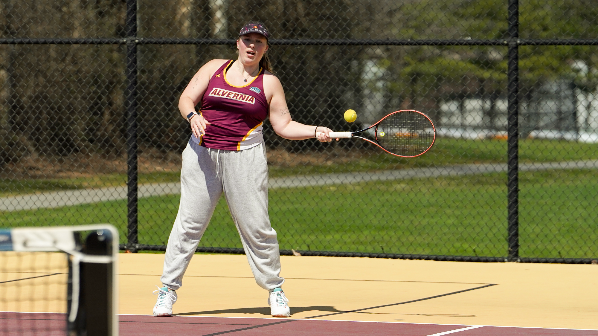 Jillian Laughman returns her opponent's serve
