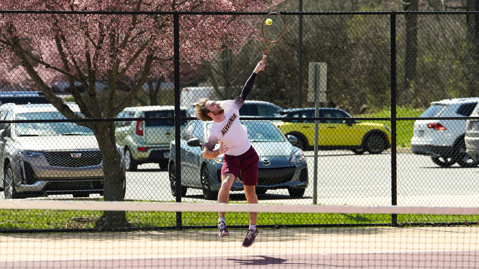 Troy O'Malley serves a ball