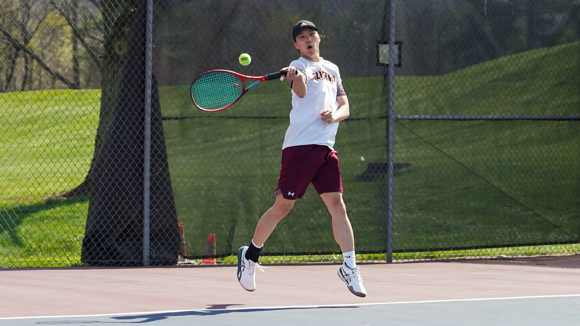 Andrew Kao returns a serve
