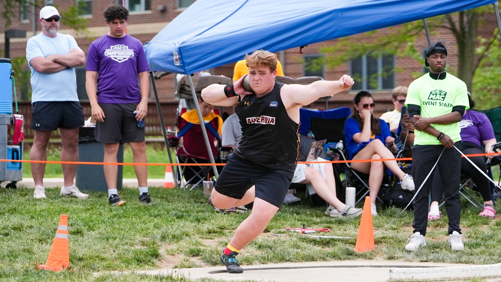Grant Sharp throws the shot put. 