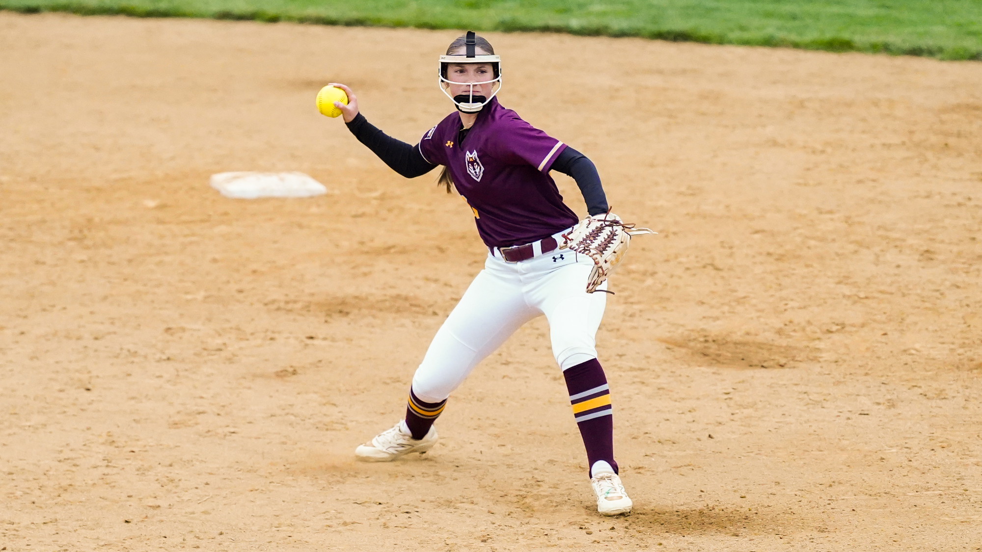 Kalli Bunnell makes a throw to first base