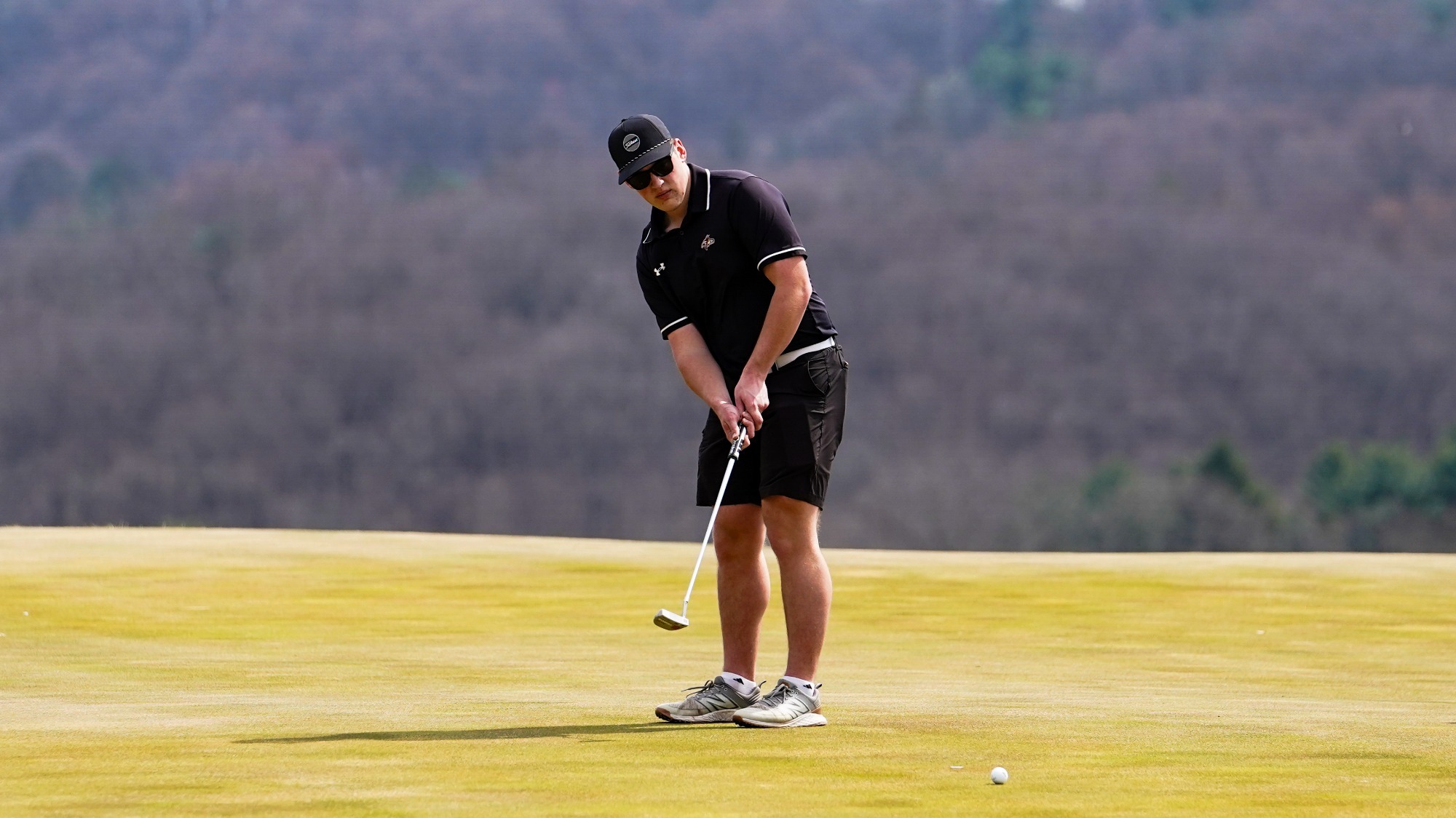 Zach Neuin rolls a put toward the cup at LedgeRock Golf Club