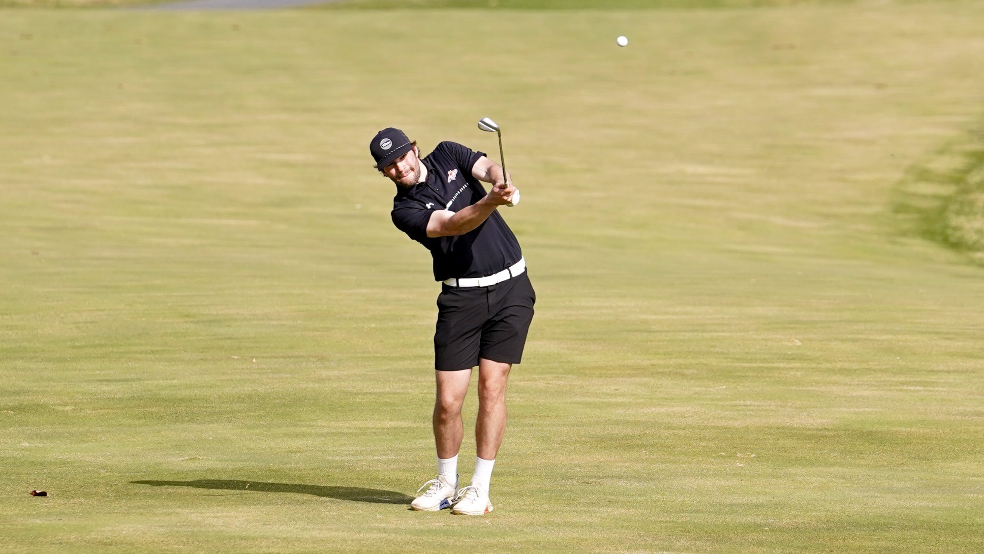 Brock Mueller hits an approach shot at LedgeRock