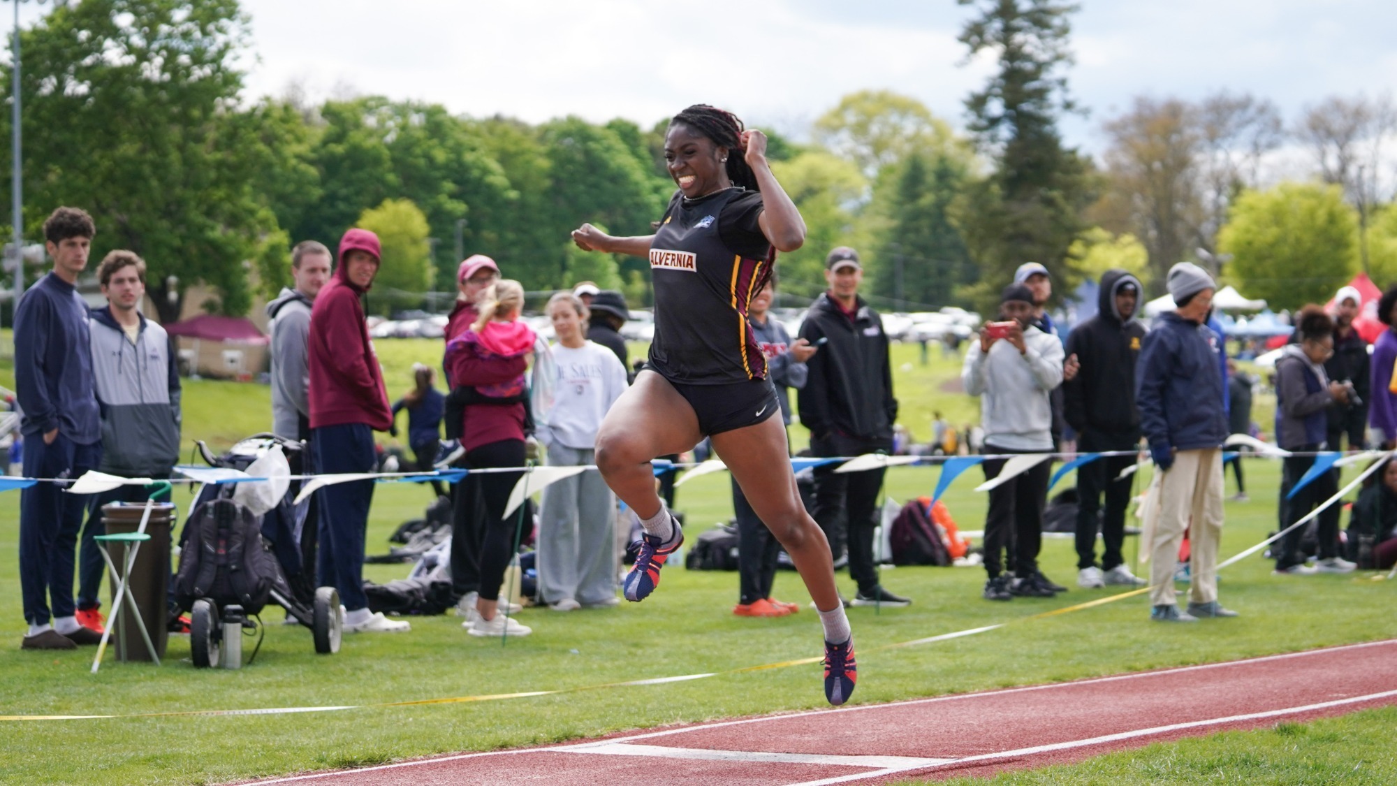Alani White attempts the triple jump at the MAC Championship