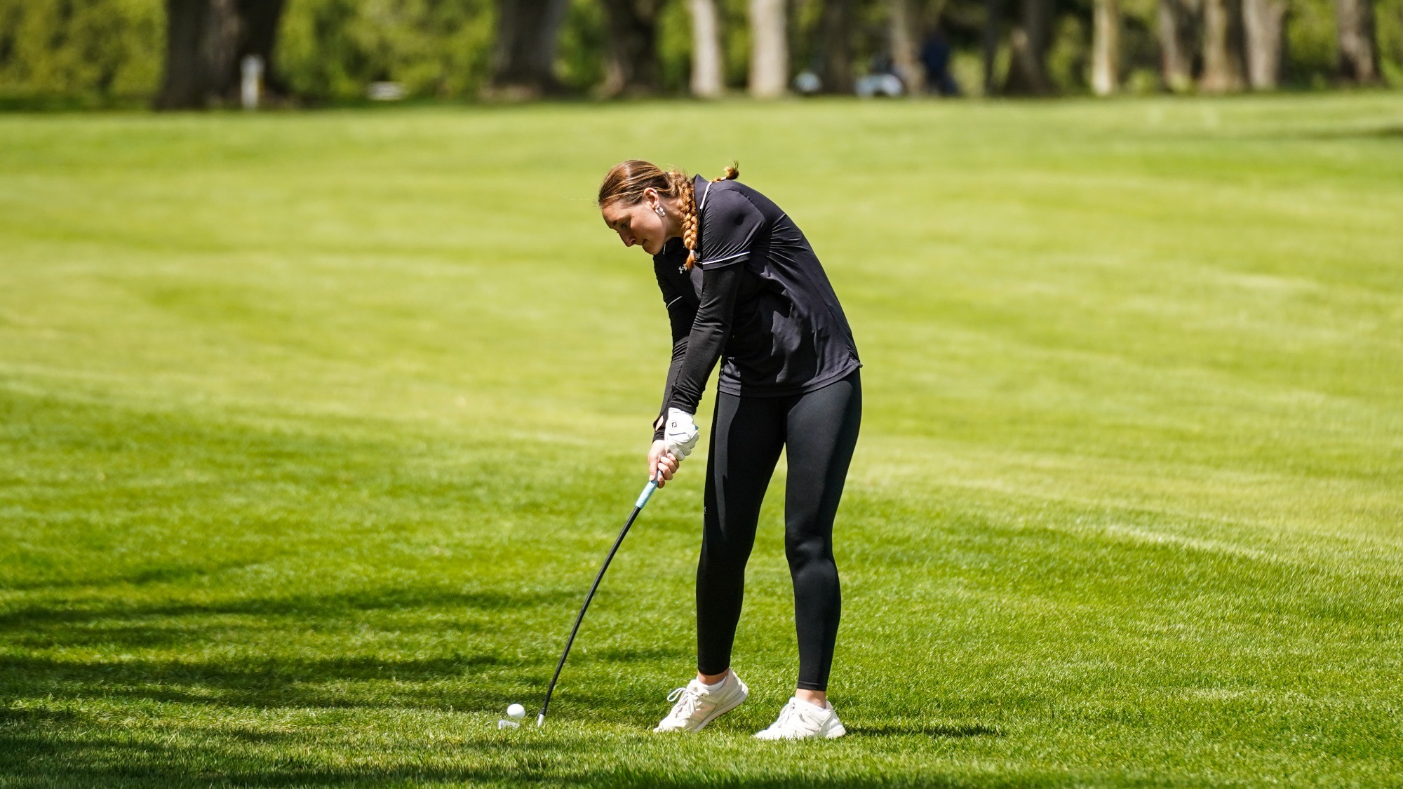 Grace Spielman hits an approach shot into the 8th green at the MAC Women's Golf Championships.