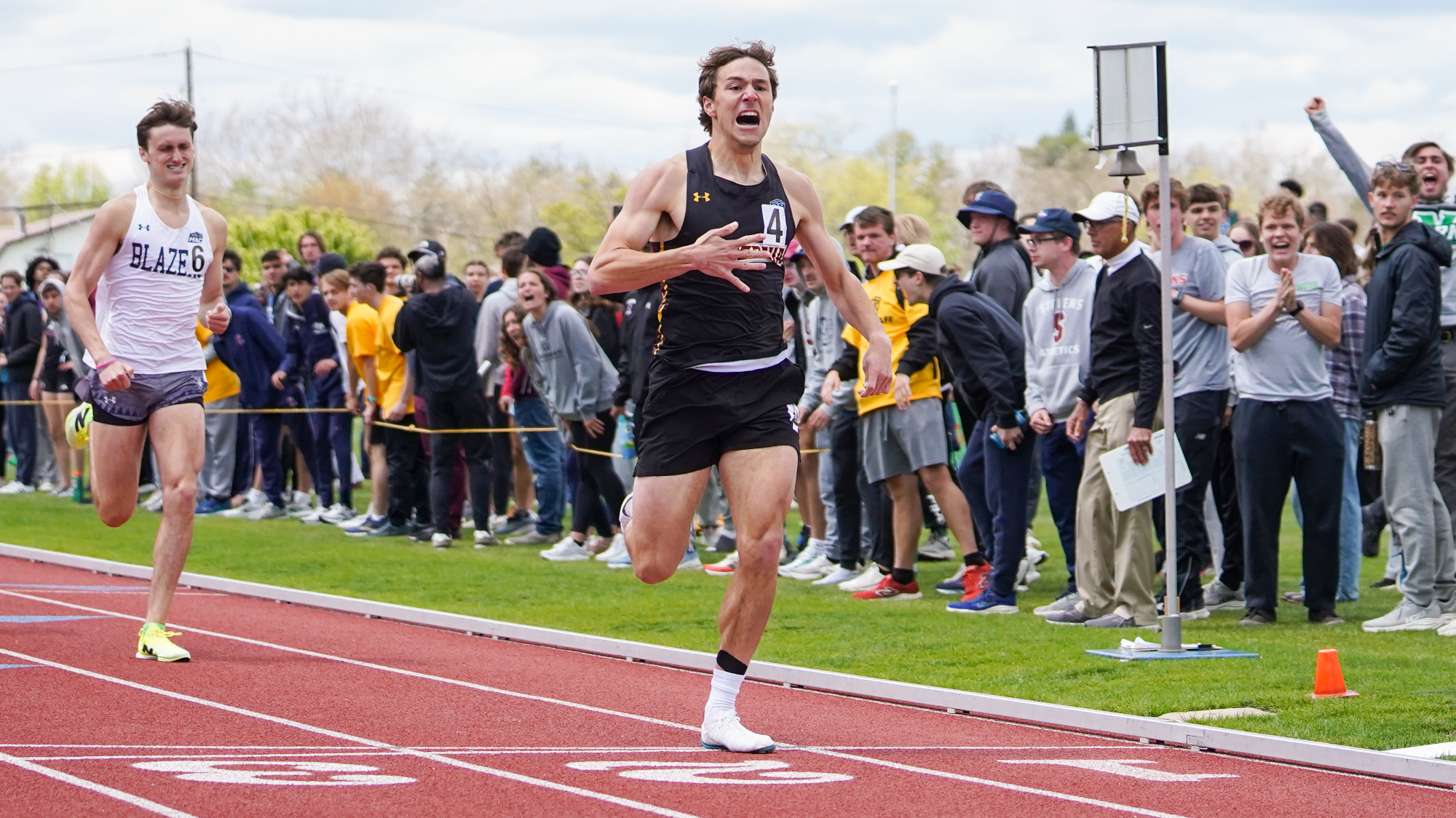 Spencer Hahn crosses the finish line first in the 800 meter final race