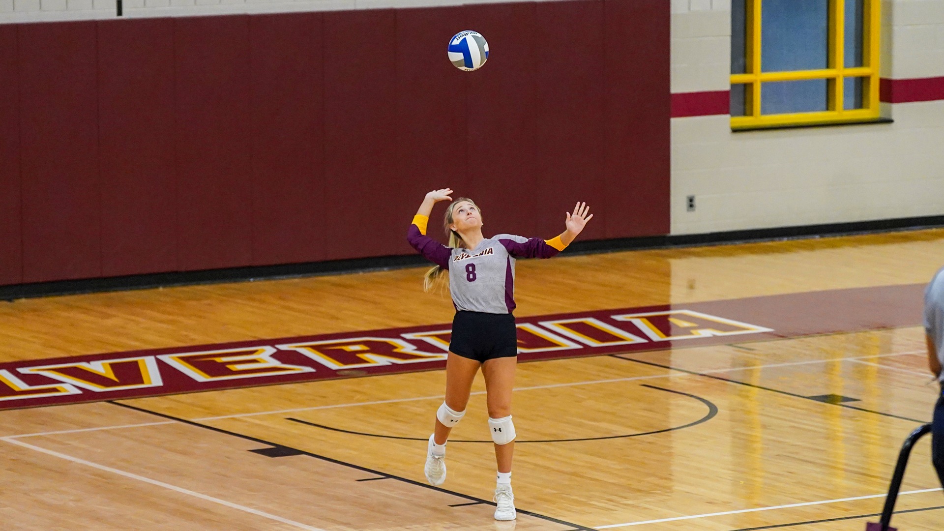 Caroline Buggy serves the volleyball
