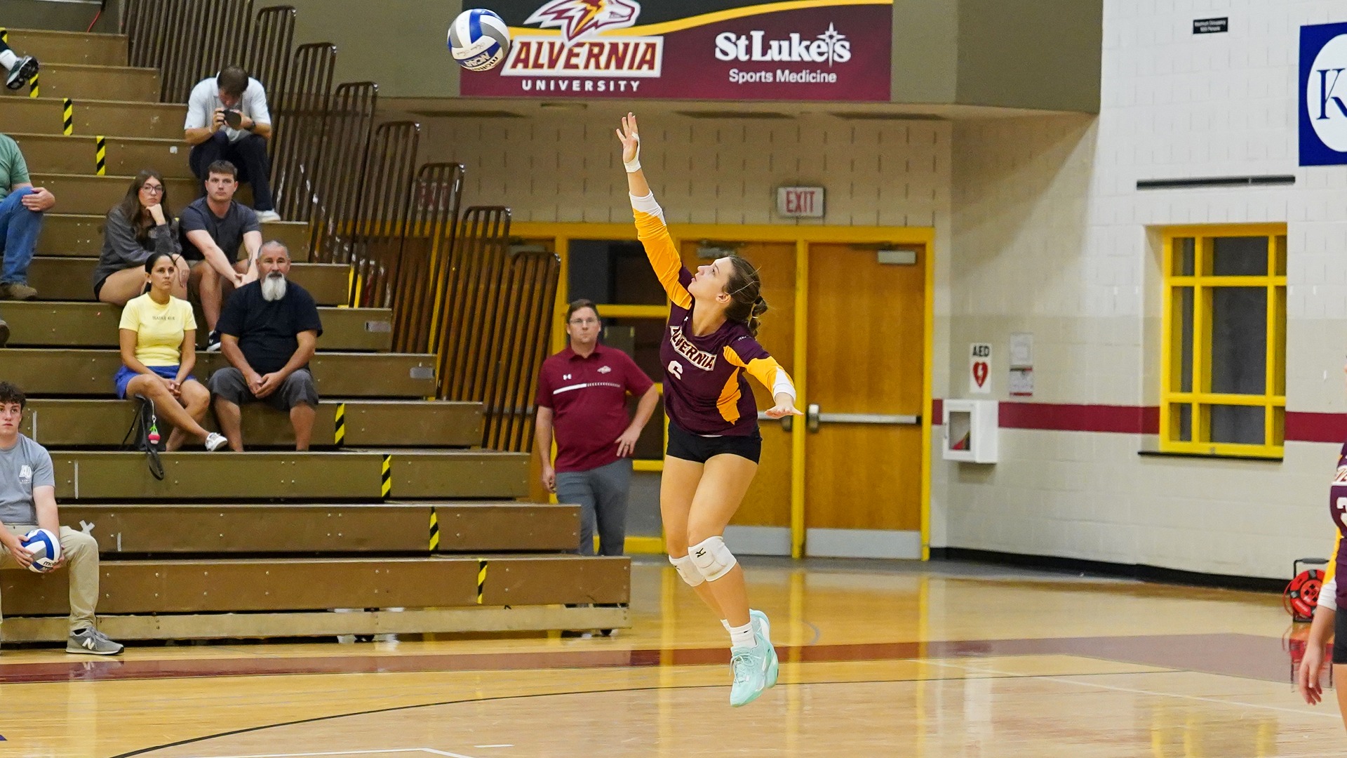 Von Neida serves the ball
