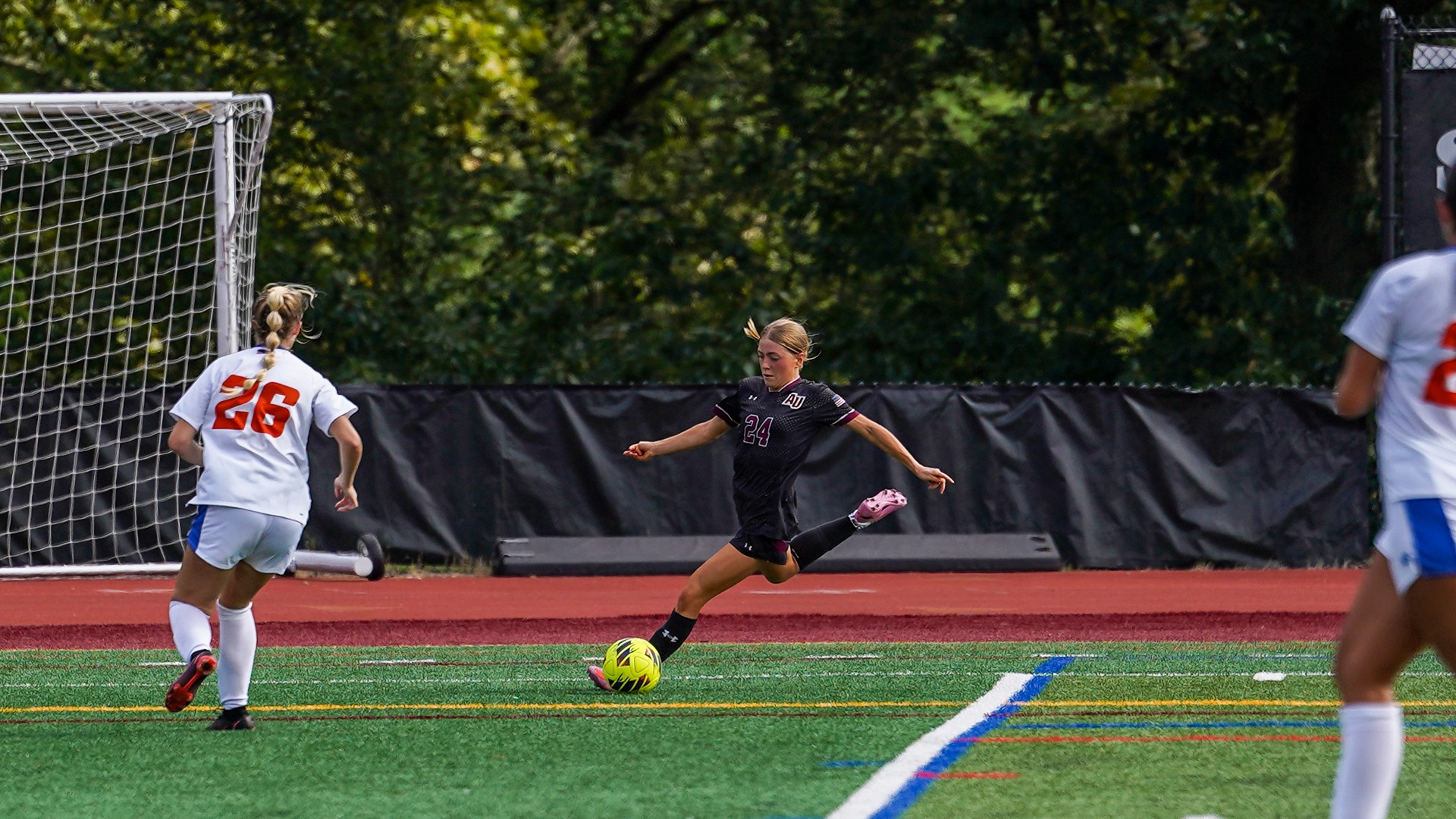 Faith Greenday plays a cross into the box against Coast Guard