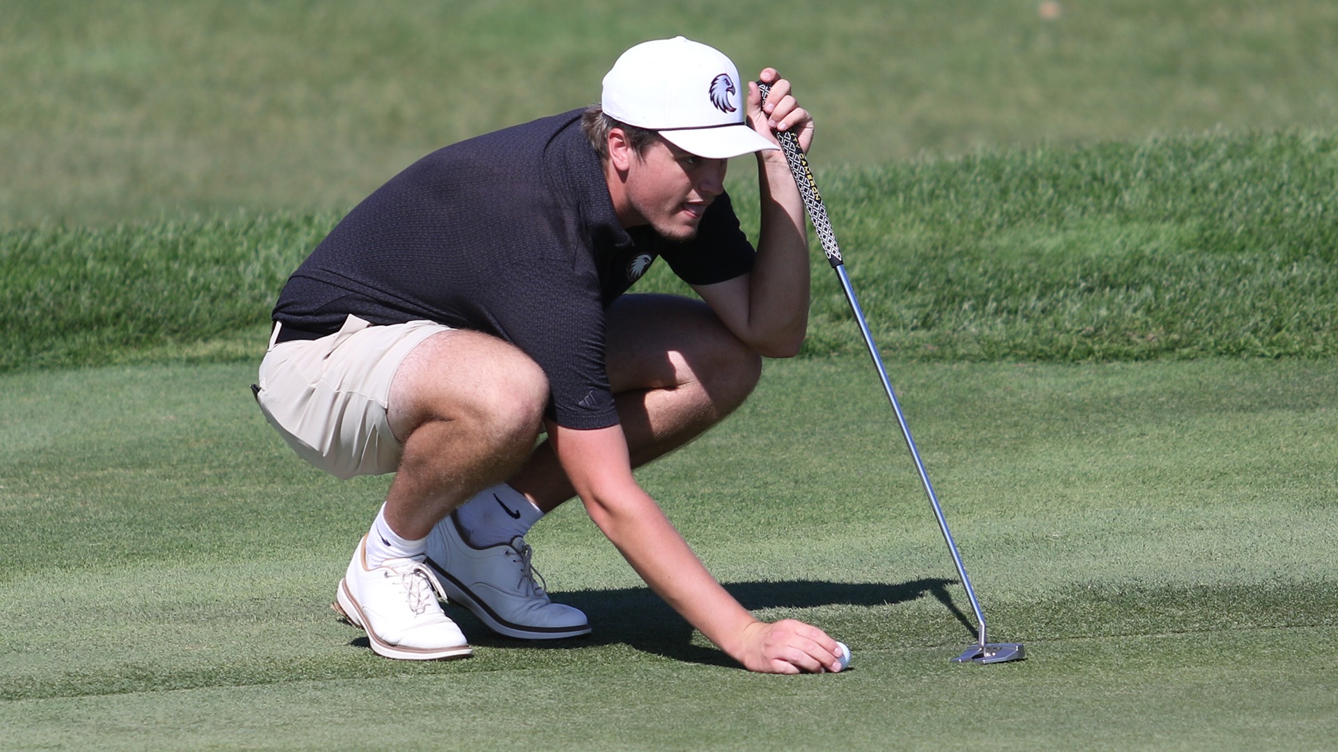 Max Gundlach lines up a putt during a 2025-26 Augsburg men's golf meet.