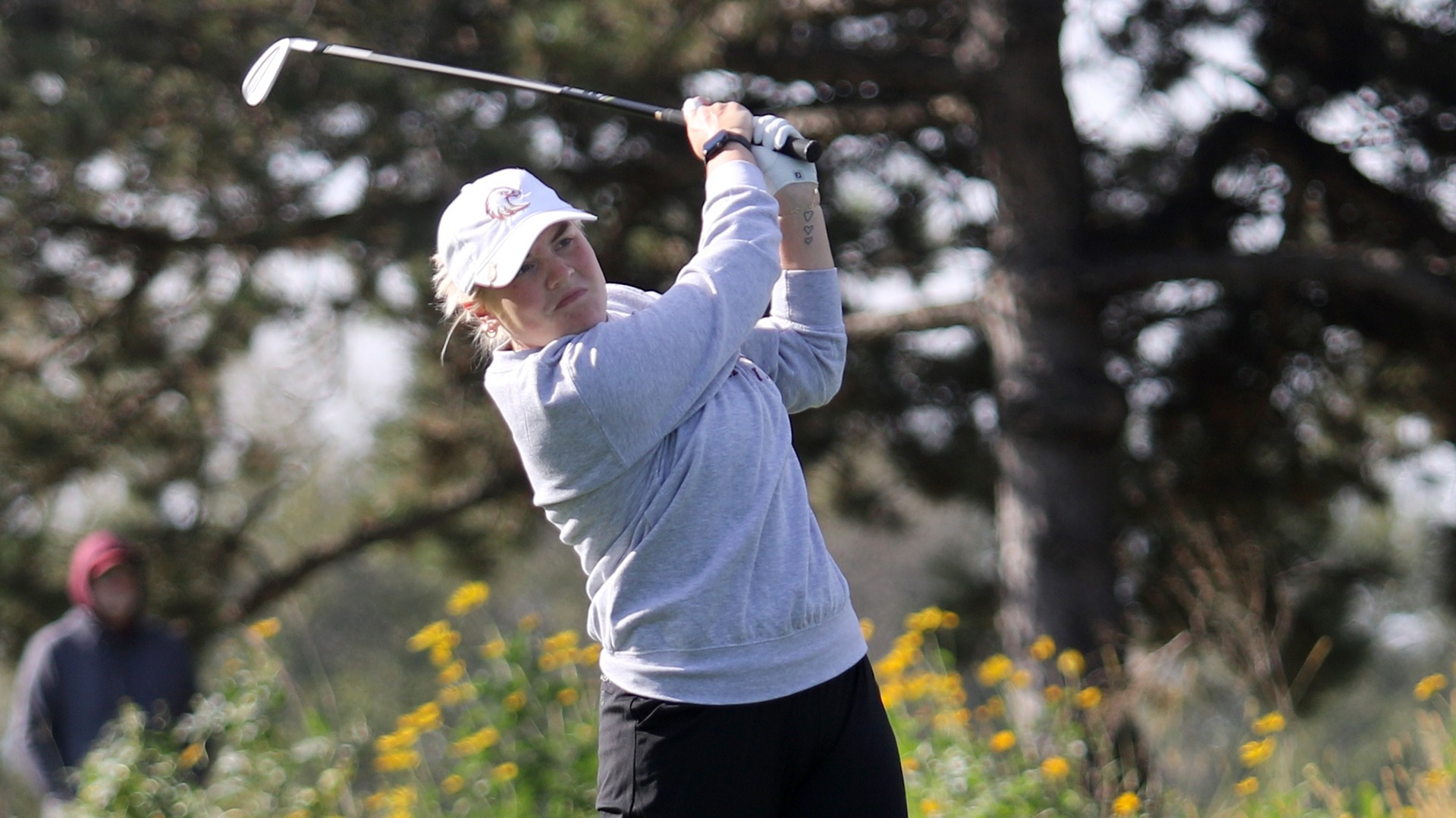 Emma Larsen tees off during a 2025-26 Augsburg women's golf meet.