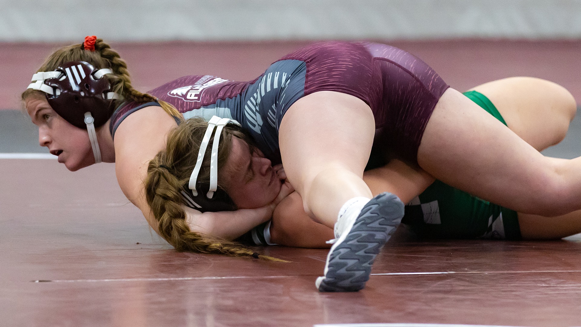 Paige Haaf attempts to pin her opponent during a 2025-26 Augsburg women's wrestling meet.