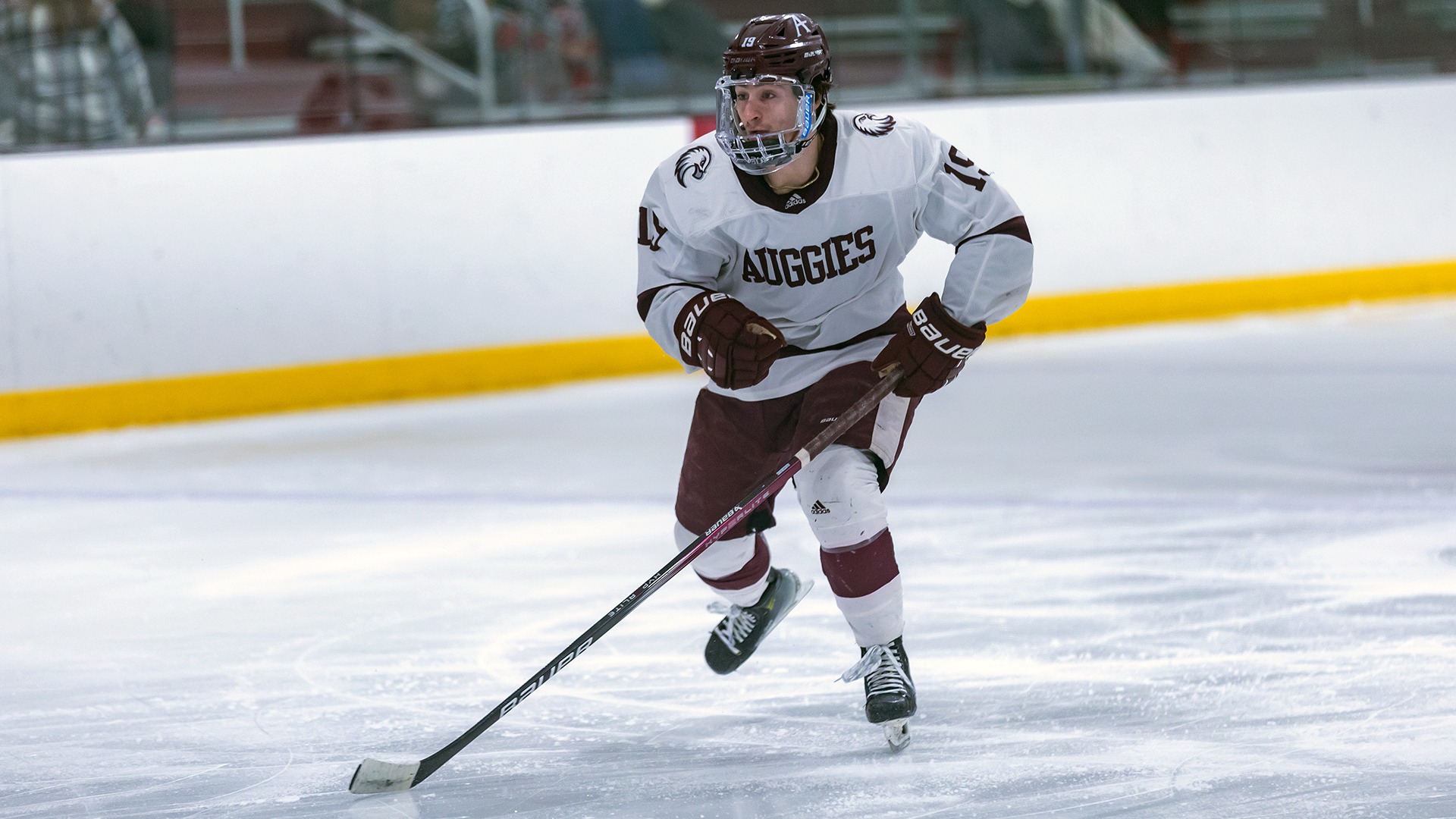 Nick Catalano works his way up the ice during a 2024-25 Augsburg men's hockey game.