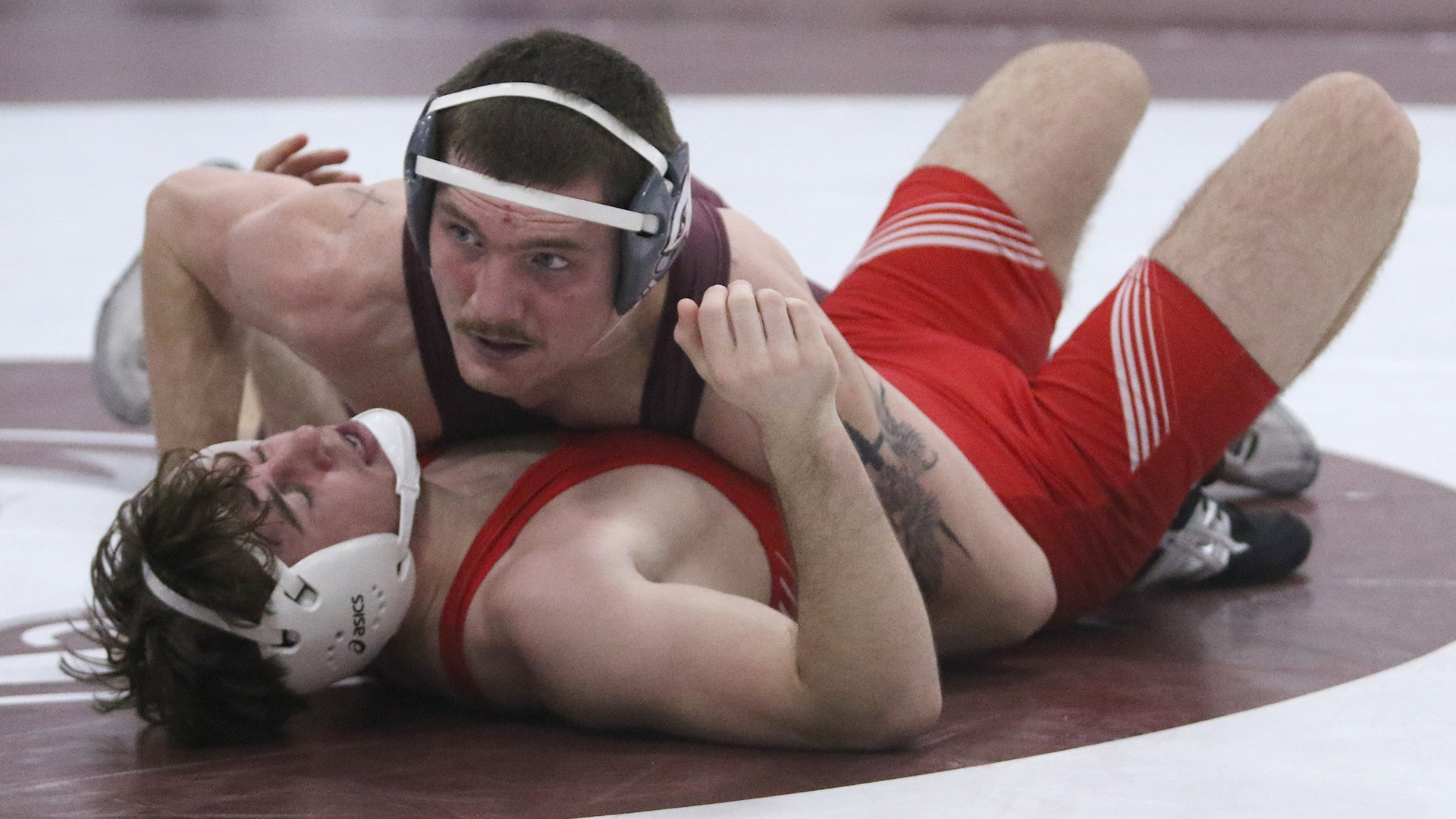 Karsen Otis pins an opponent during a 2025-26 Augsburg men's wrestling meet.