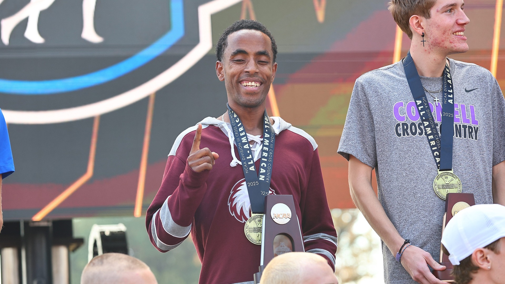 Mohammed Bati smiles as he receives his All-America medal at the 2025 NCAA Division III Men's Cross Country National Championships.