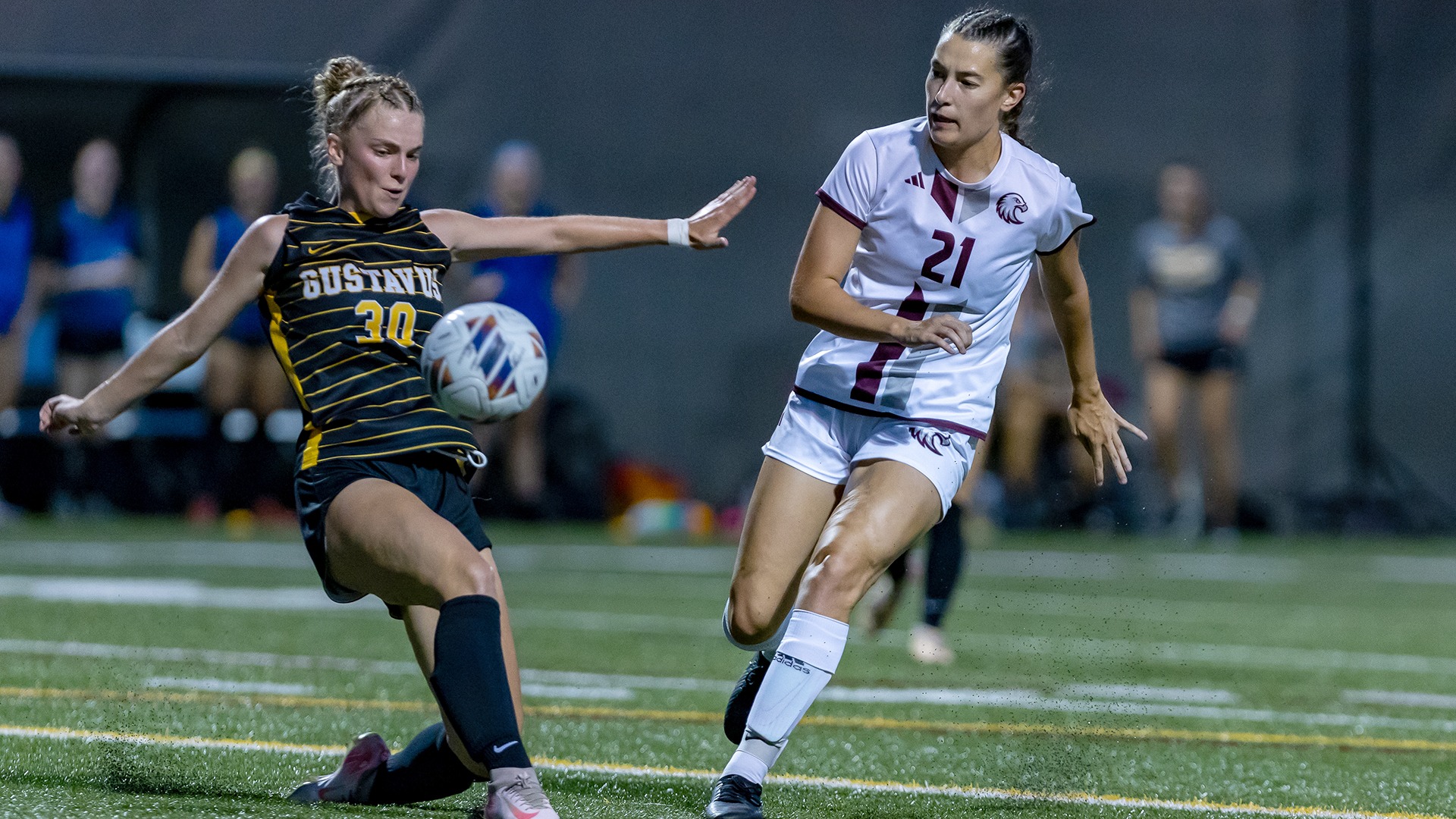 Allison Hookom plays the ball against a defender during a 2025 Augsburg women's soccer game.