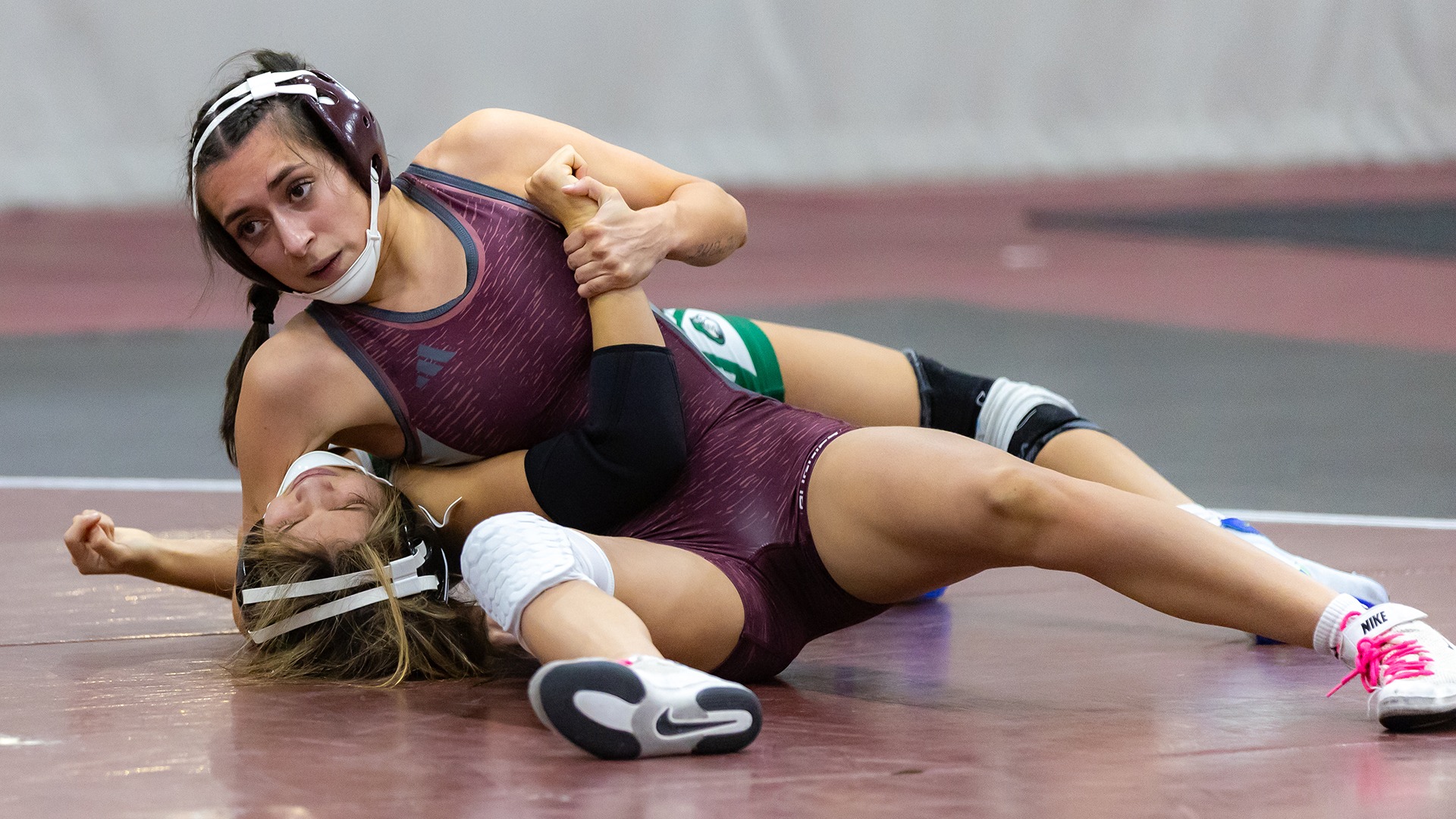 Kelsey Cruz Rojas has an opponent in a headlock during a 2025-26 Augsburg women's wrestling meet.
