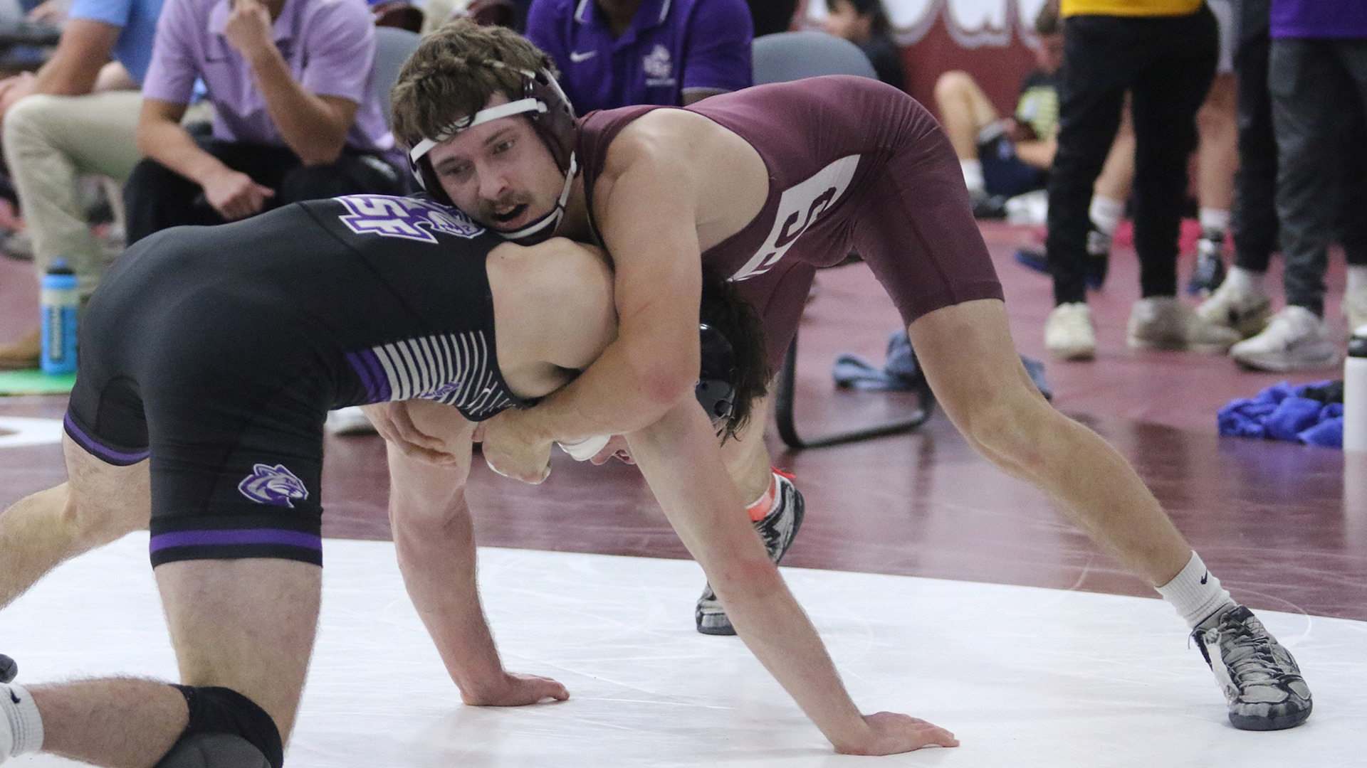 Cade Wilson controls the head of an opponent during a 2025-26 Augsburg men's wrestling meet.