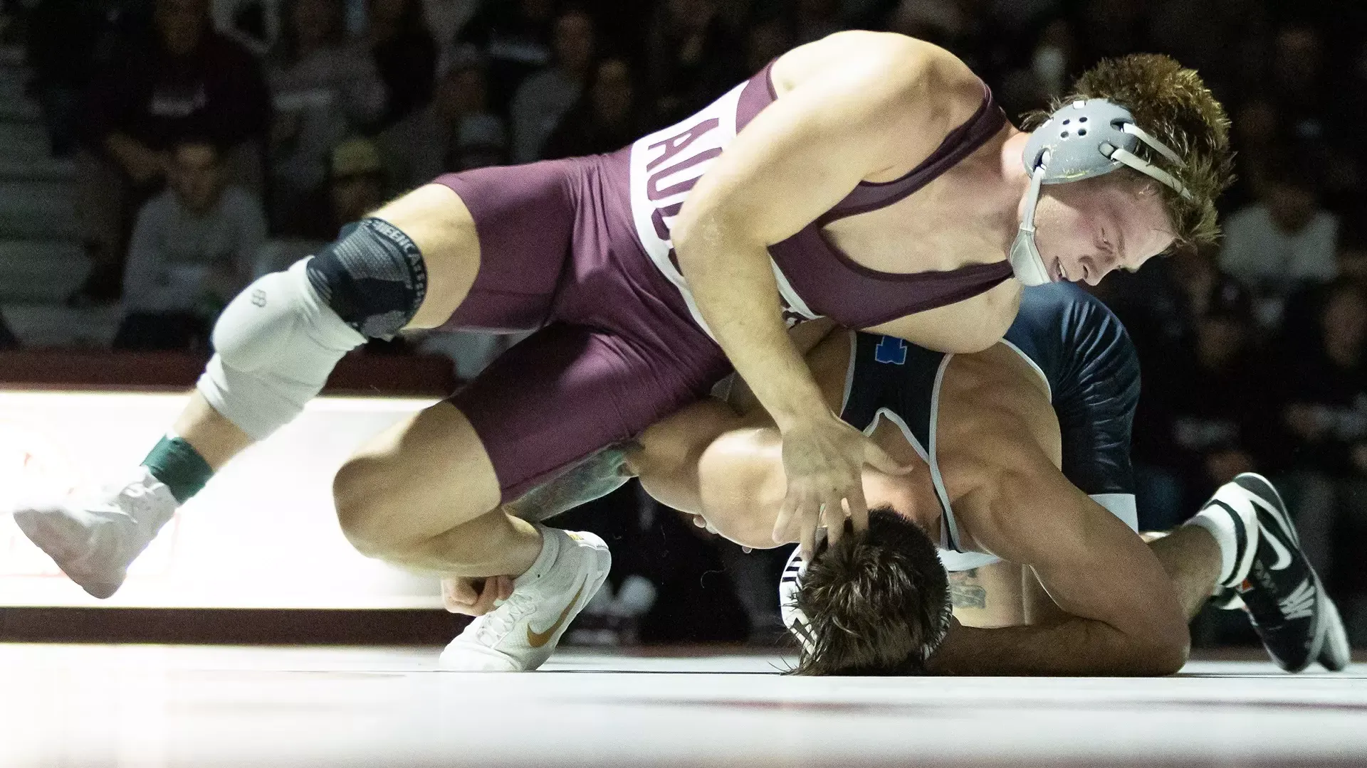 Brandt Bombard slides away from an opponent during a 2025-26 Augsburg men's wrestling meet.