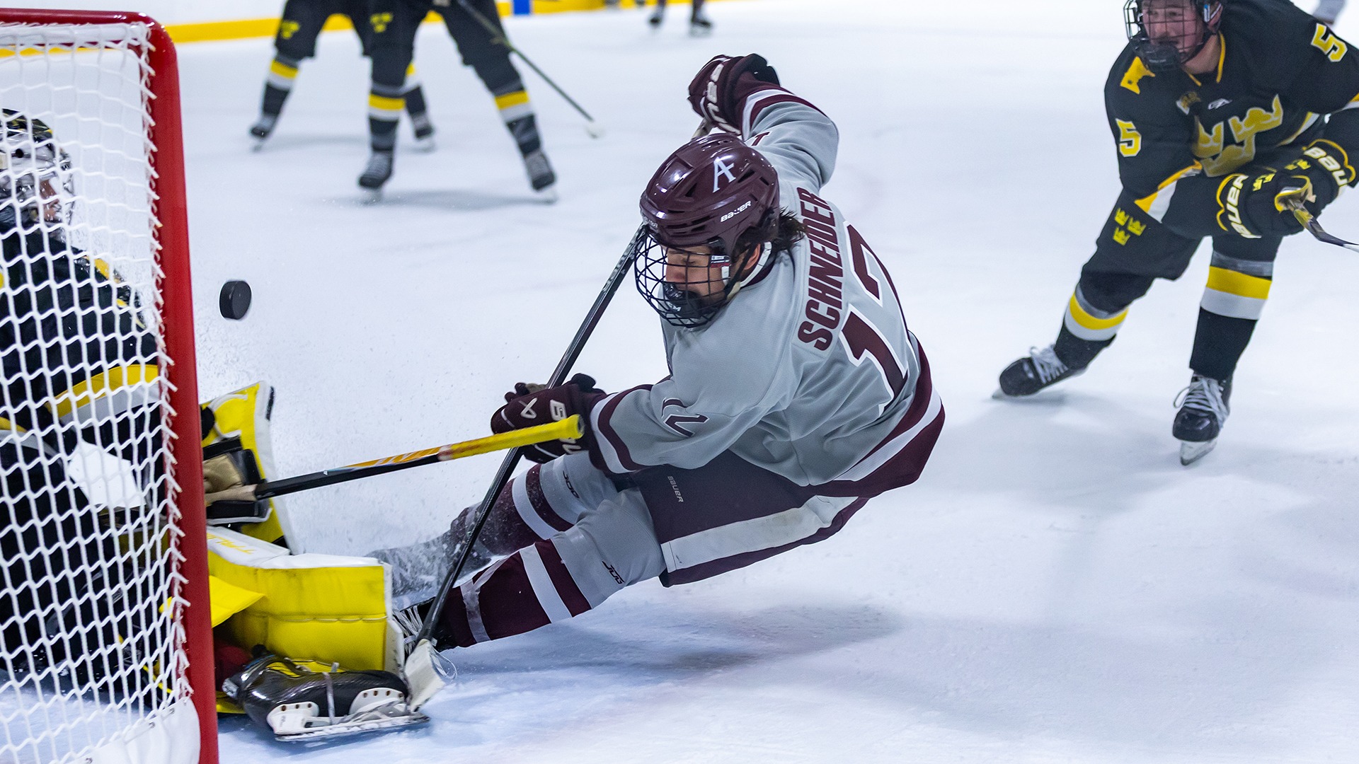 Conner Schneider scores a goal during a 2025-26 Augsburg men's hockey game.