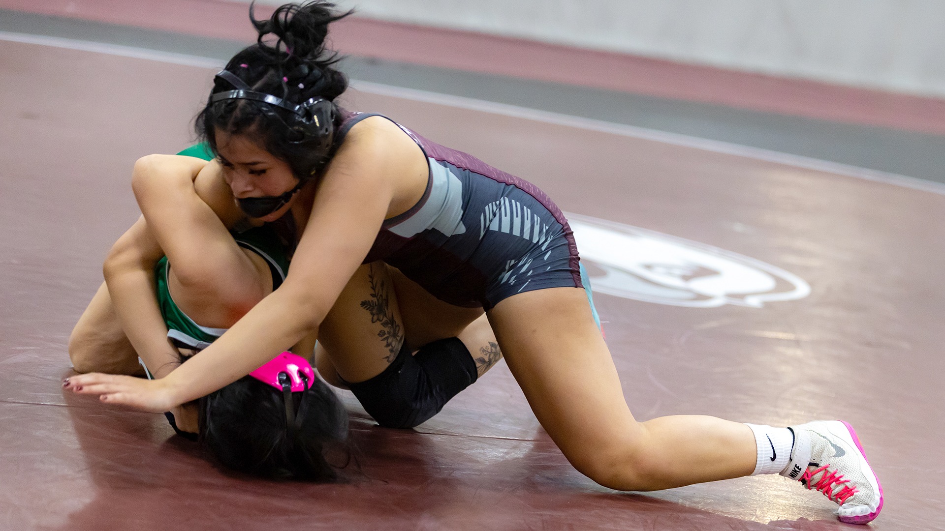 Kelsey Cruz Rojas controls her opponent during a 2025-26 Augsburg women's wrestling meet.