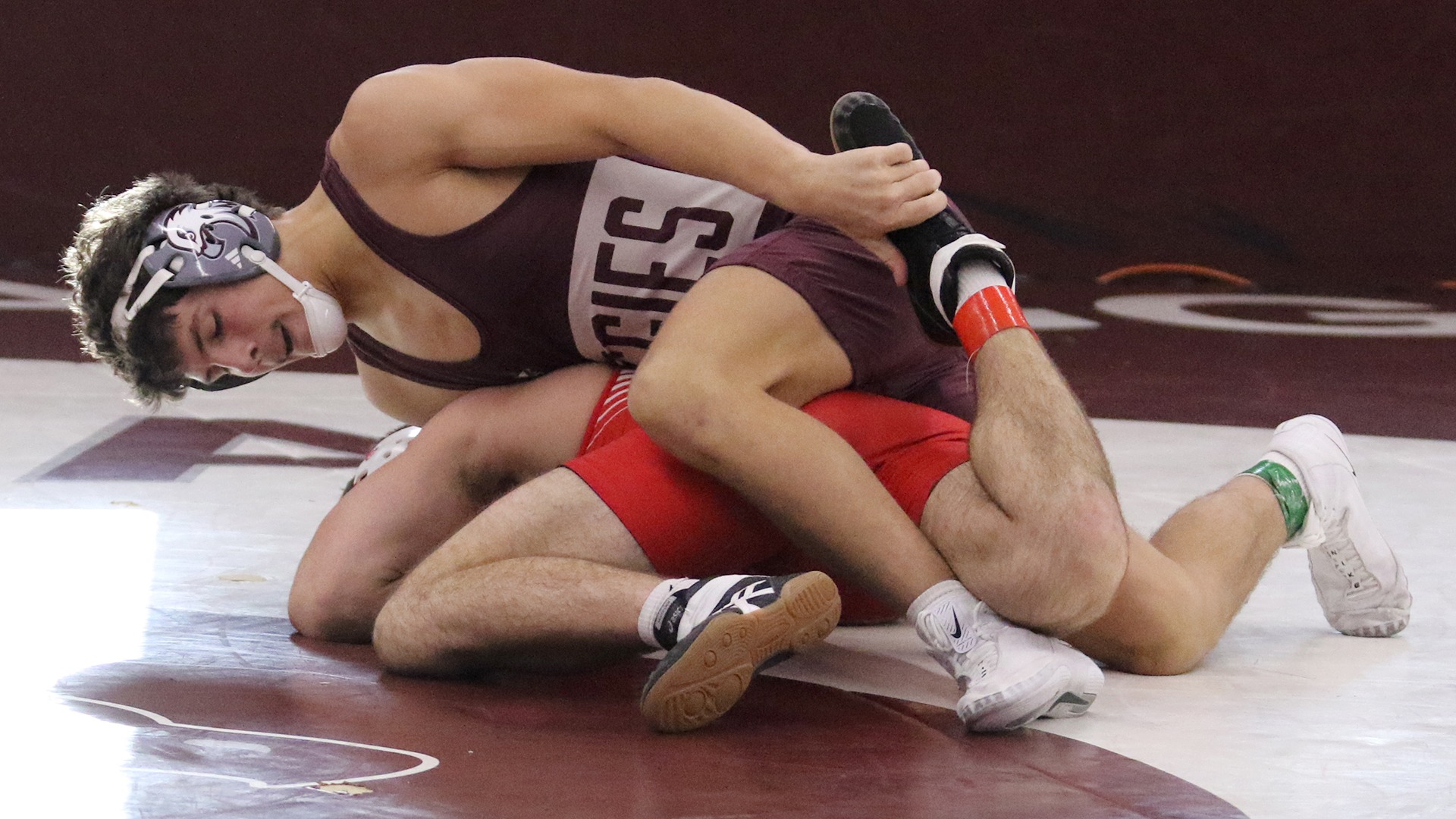 Colton Loween controls the leg of his opponent during a 2025-26 Augsburg men's wrestling meet.