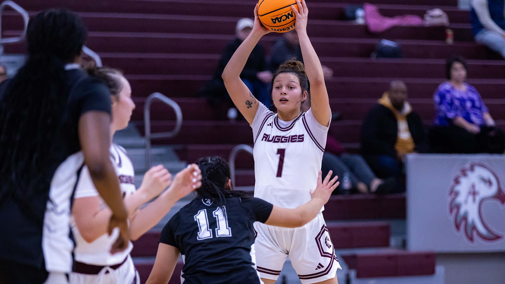 Lani Fonoti looks for someone to pass to during a 2025-26 Augsburg women's basketball game.