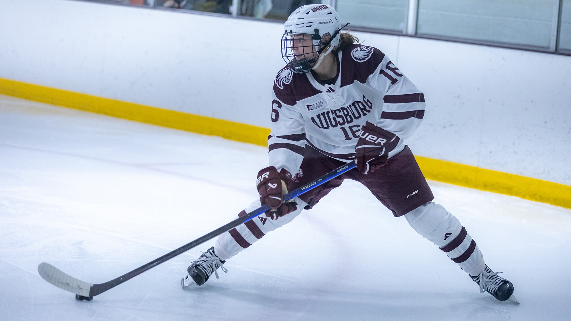 Kate Haug handles the puck during a 2025-26 Augsburg women's hockey game.