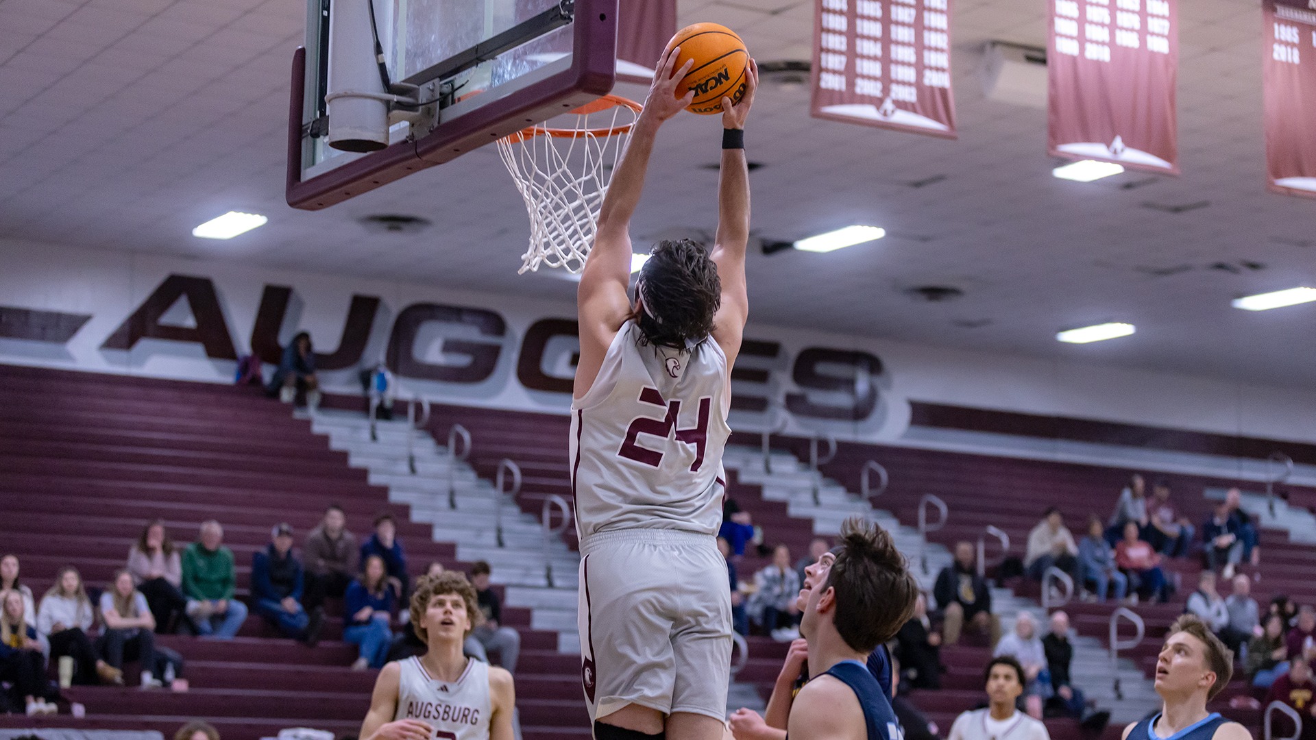 Isaac Rabaey goes up for a dunk during a 2025-26 Augsburg men's basketball game.