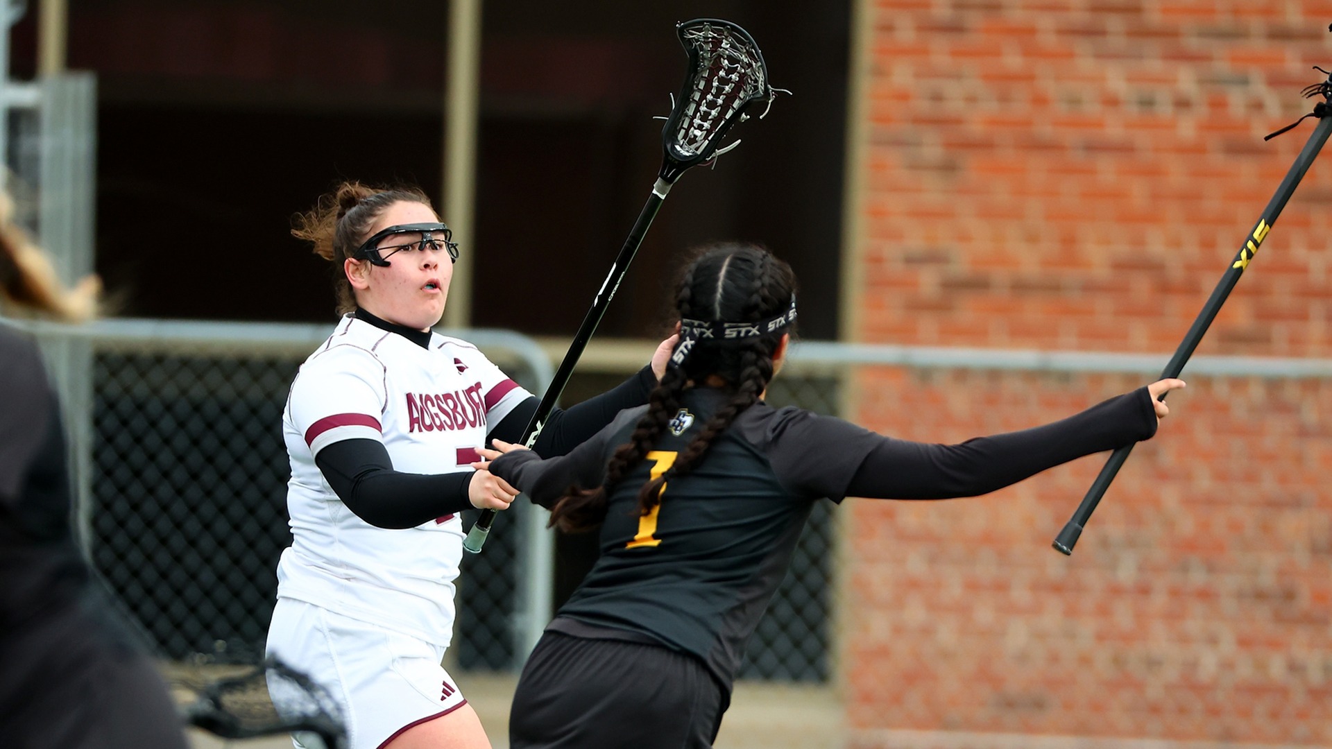 Eleanor Flynn faces a defender during a 2025 Augsburg women's lacrosse game.