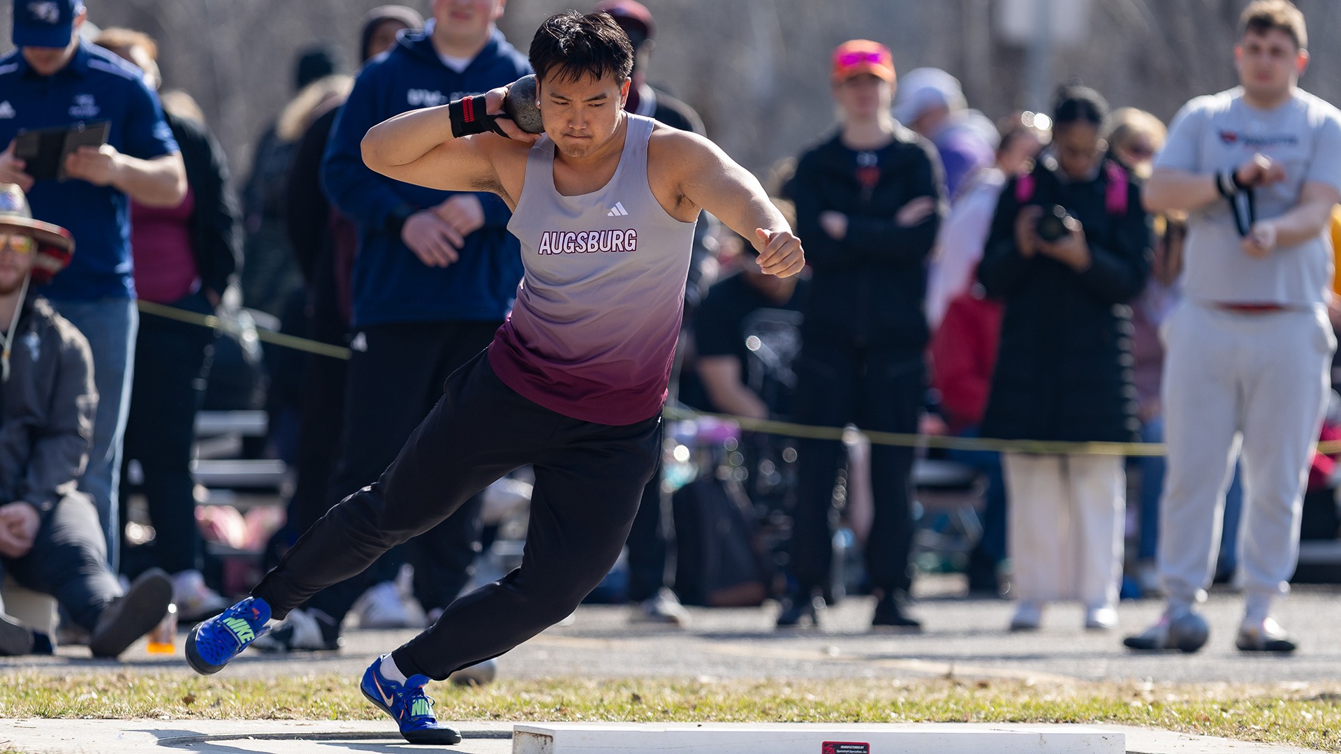 Joshua Lor throws the shot put during a 2025 Augsburg track and field meet.
