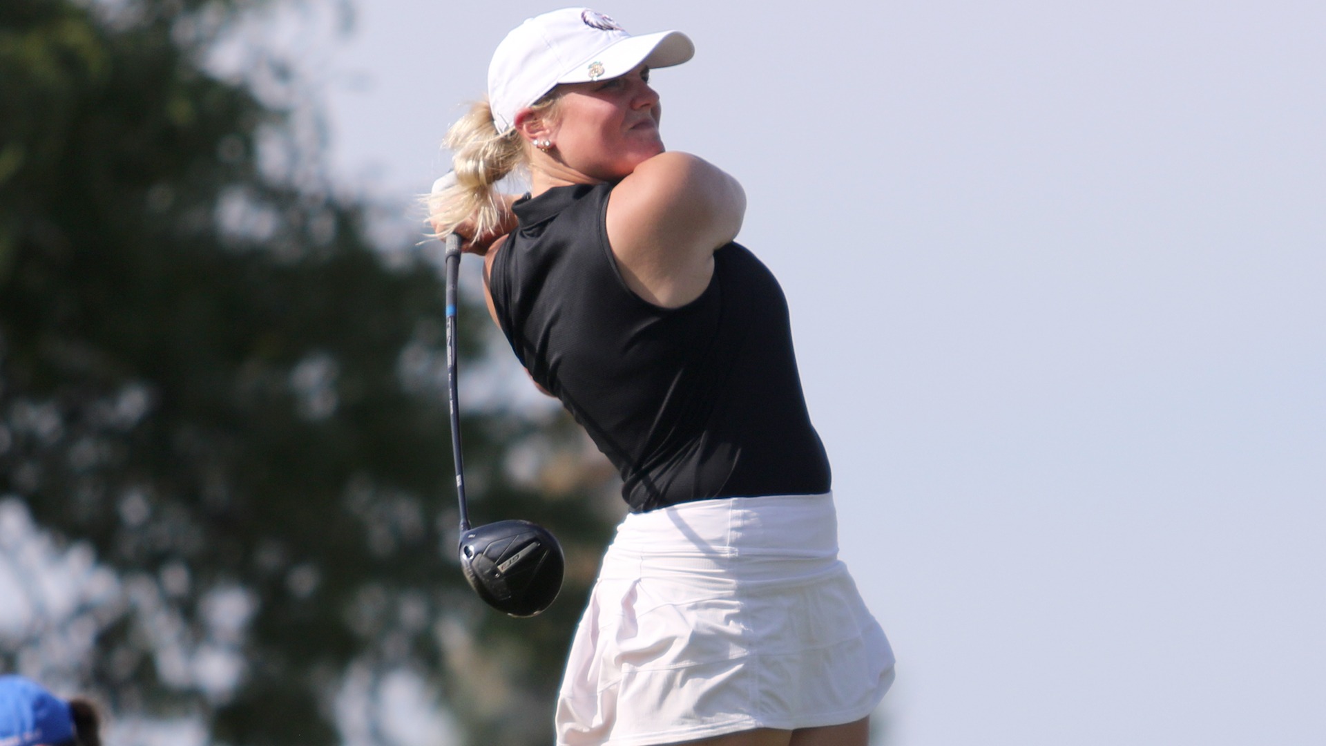 Emma Larsen tees off during a 2025-26 Augsburg women's golf meet.