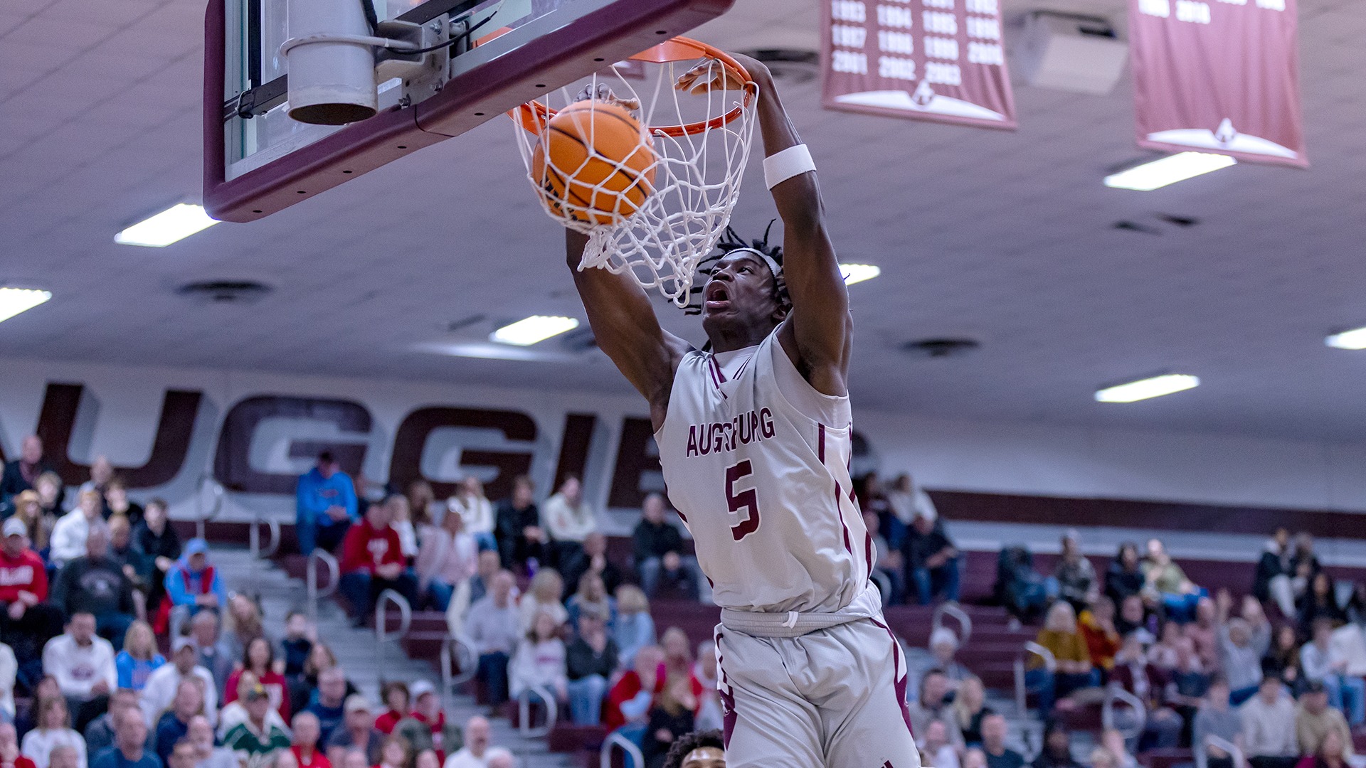 Elias Batala dunks the ball during a 2025-26 Augsburg men's basketball game.