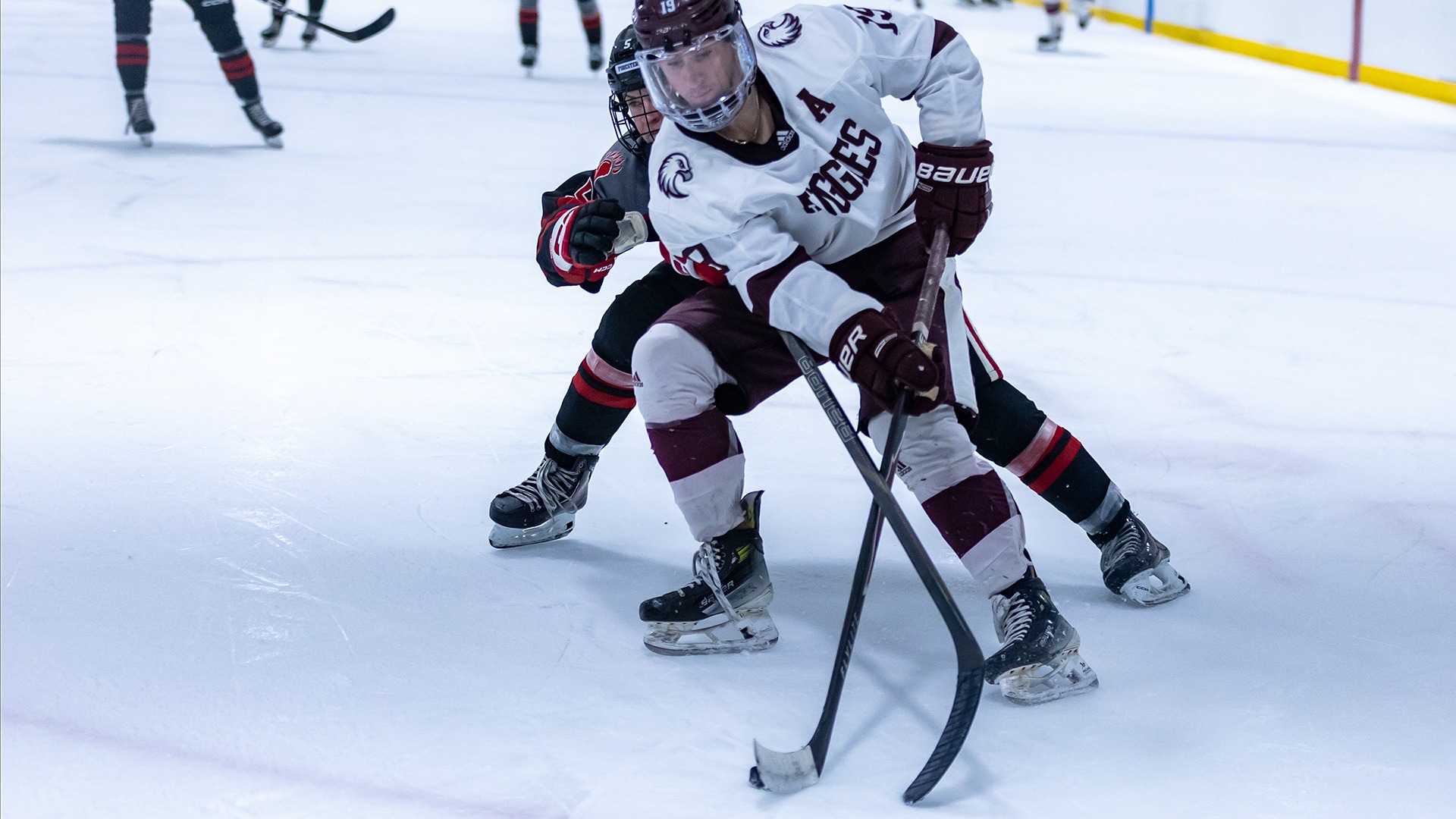 Nick Catalano handles the puck during a 2025-26 Augsburg men's hockey game.