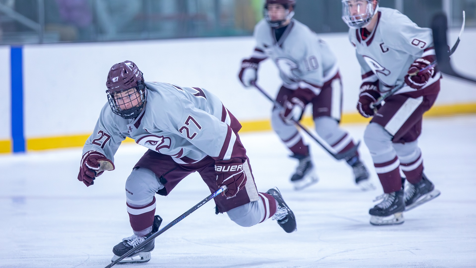 Cade Stibbe skates up the ice during a 2025-26 Augsburg men's hockey game.