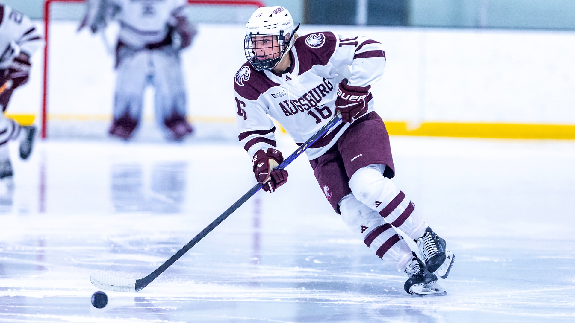 Kate Haug brings the puck up the ice during a 2025-26 Augsburg women's basketball game.