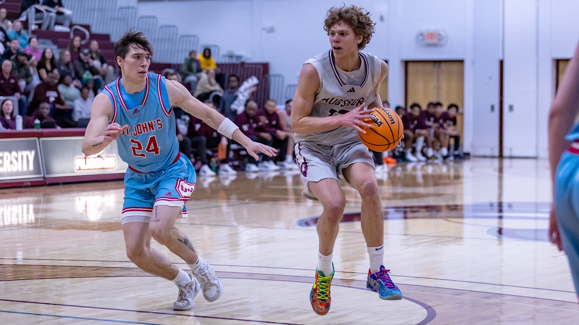JJ Semanko handles the ball in the lane during a 2025-26 Augsburg men's basketball game.