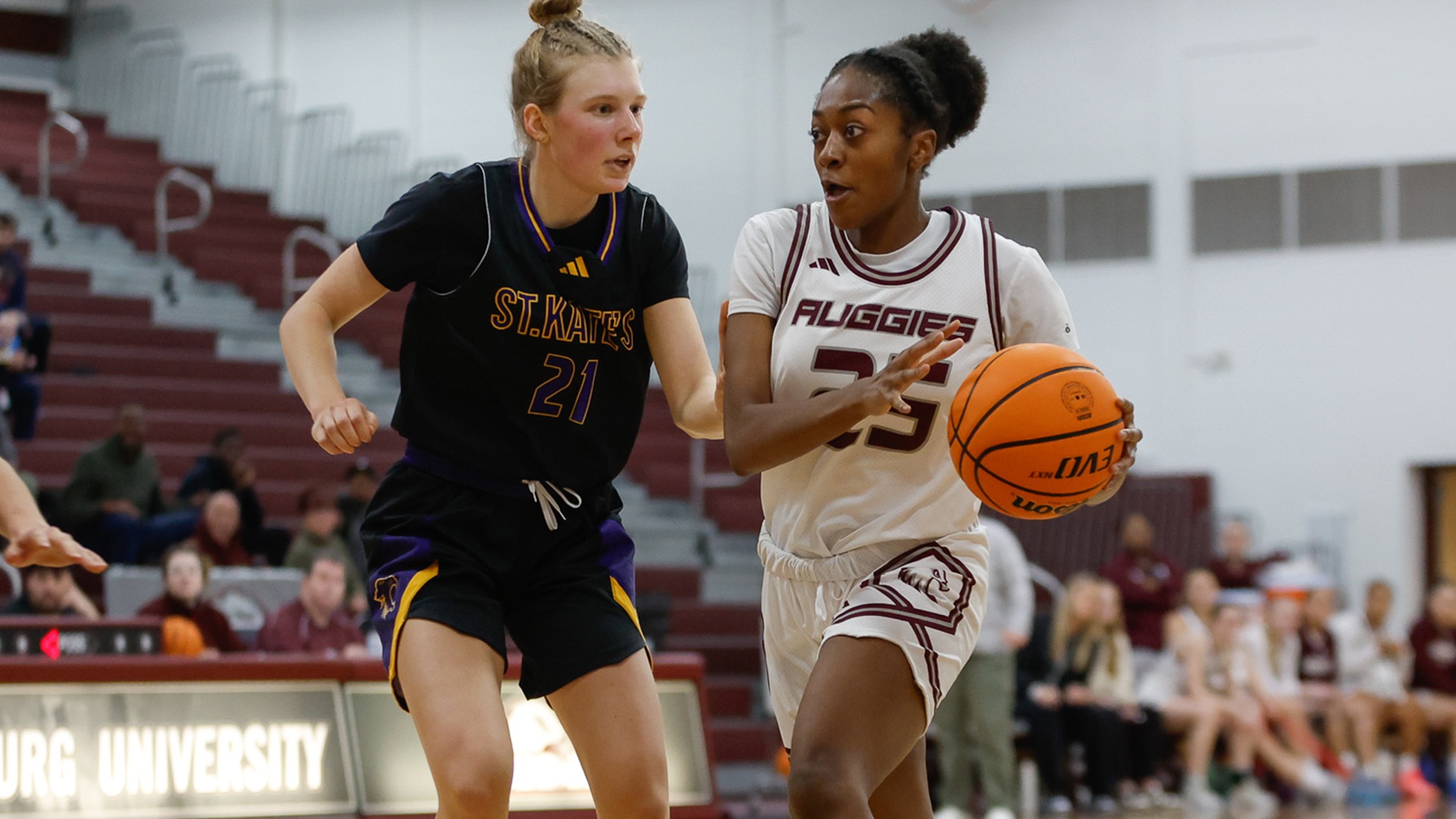 Jada Stanford drives against an opponent during a 2025-26 Augsburg women's basketball game.
