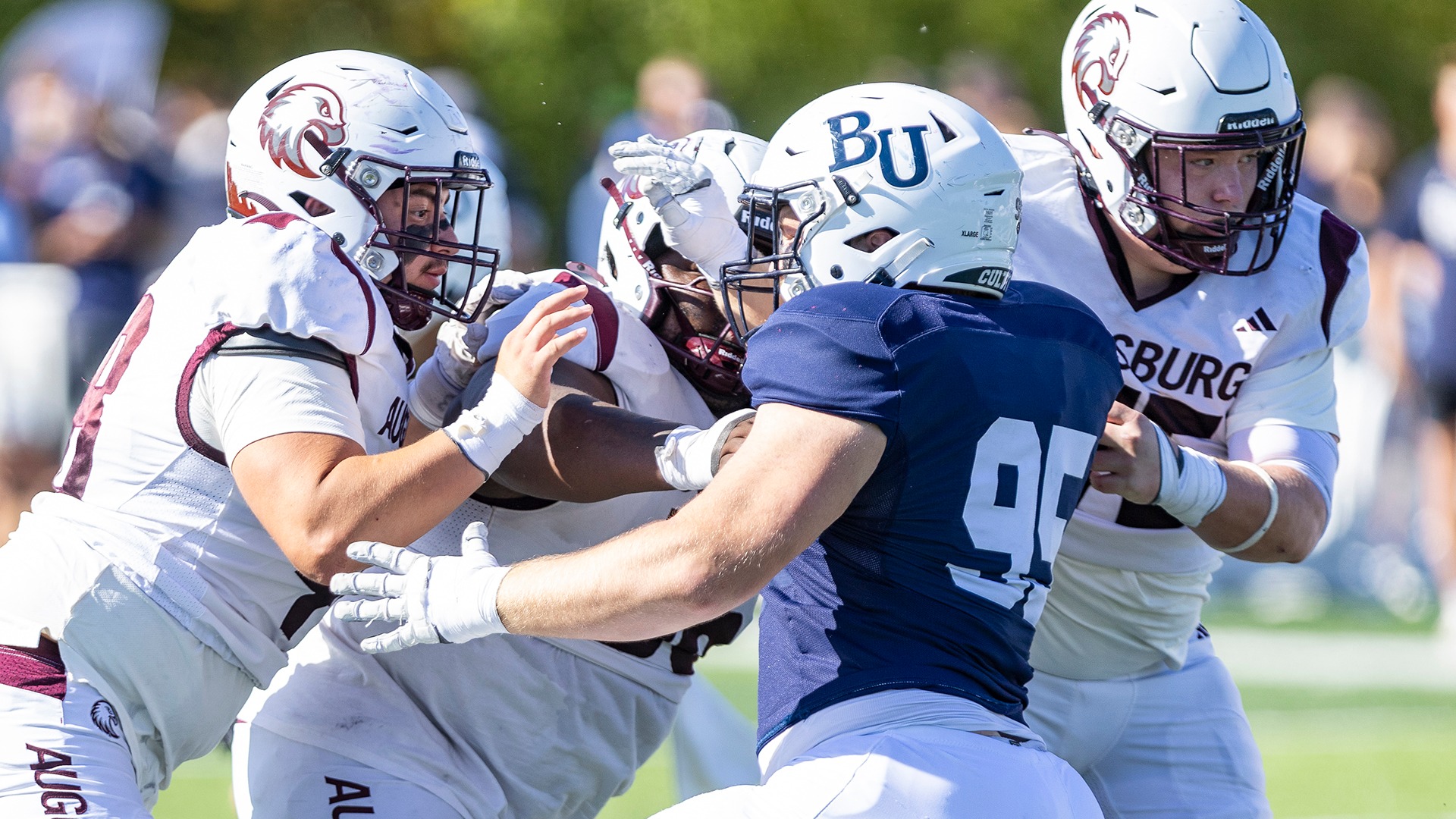 Augsburg football linemen face off with an opponent during a 2026 football game.
