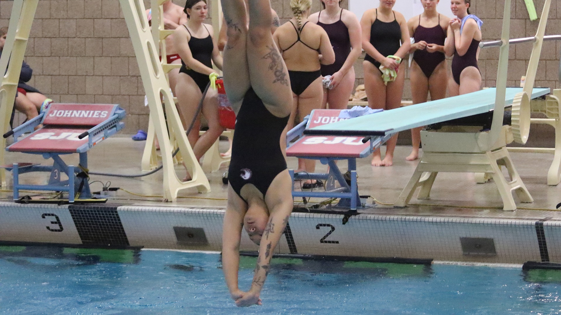 Katie Brown dives during a 2025-26 Augsburg women's swimming and diving meet.