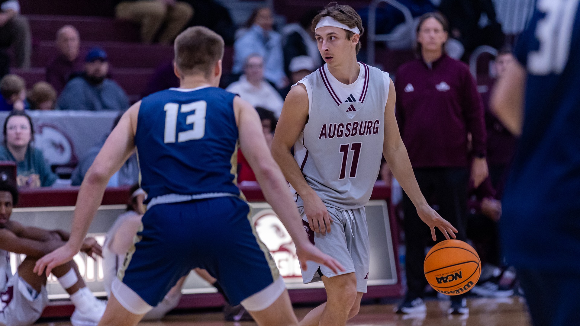 Trent Gomez handles the ball during a 2025-26 Augsburg men's basketball game.