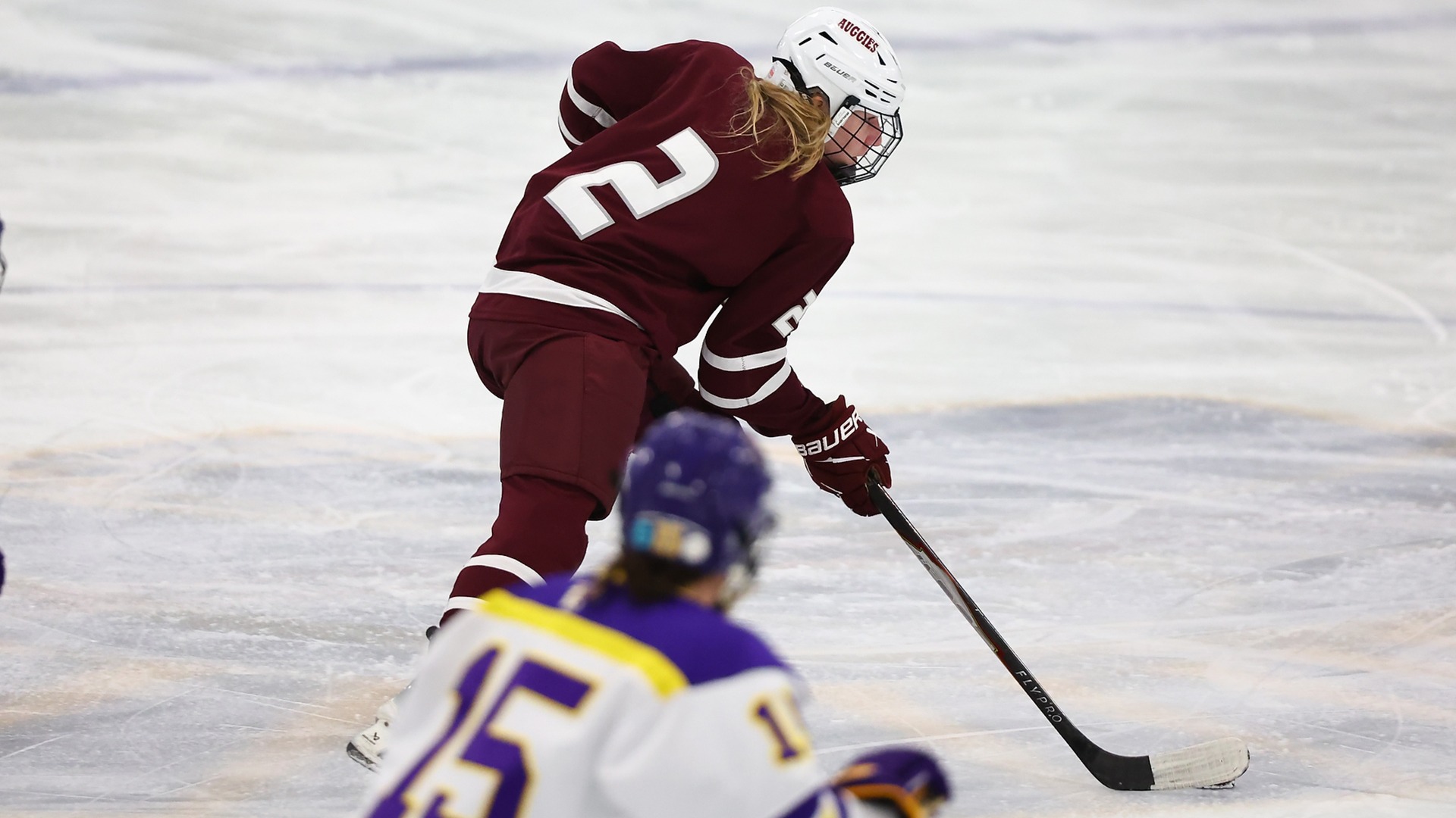 Adelyn Milota handles the puck during a 2025-26 Augsburg women's hockey game.