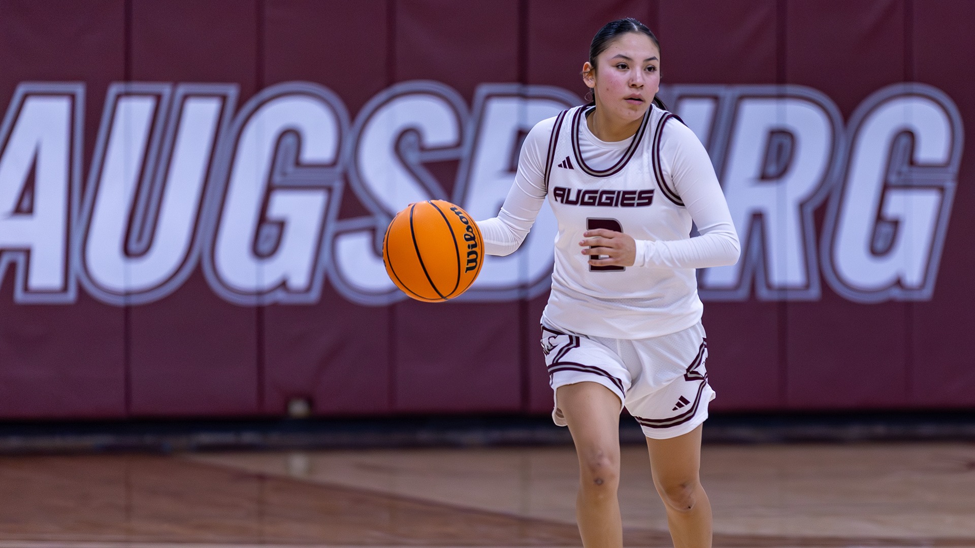 Wakinyela Bear handles the ball during a 2025-26 Augsburg women's basketball game.