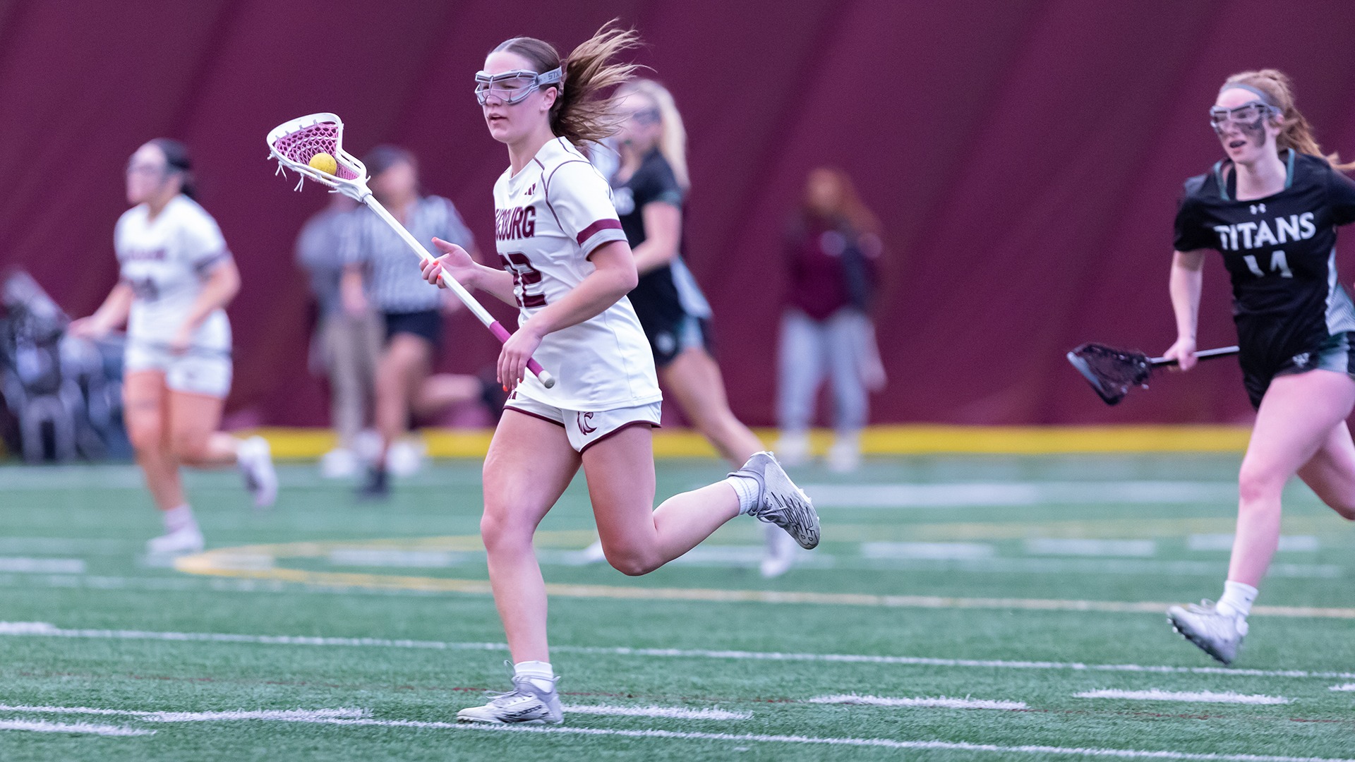Leila Klym runs with the ball during a 2025 Augsburg women's lacrosse game.