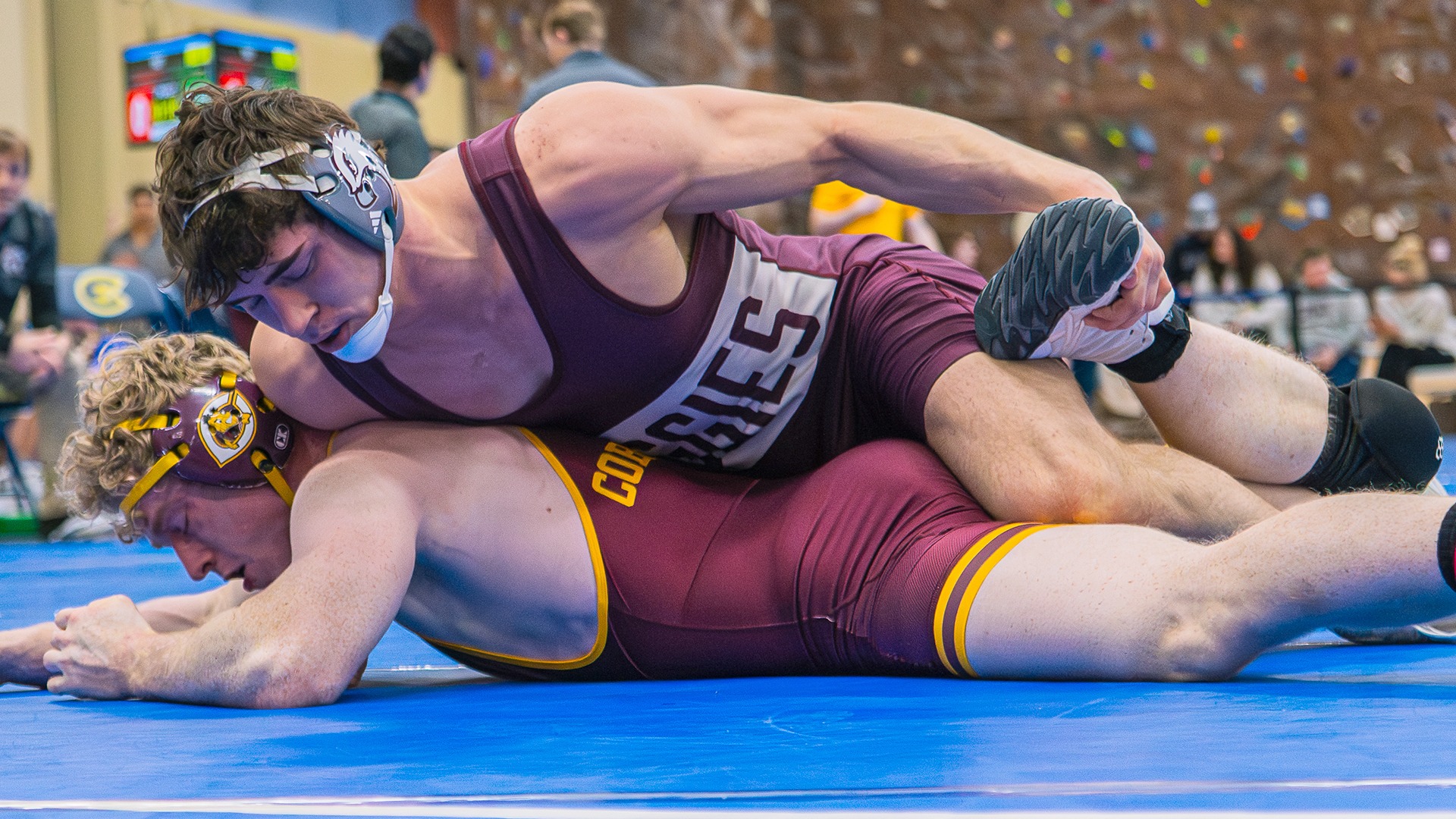 Ethan Winkelman has leg control on an opponent during a 2025-26 Augsburg men's wrestling meet.