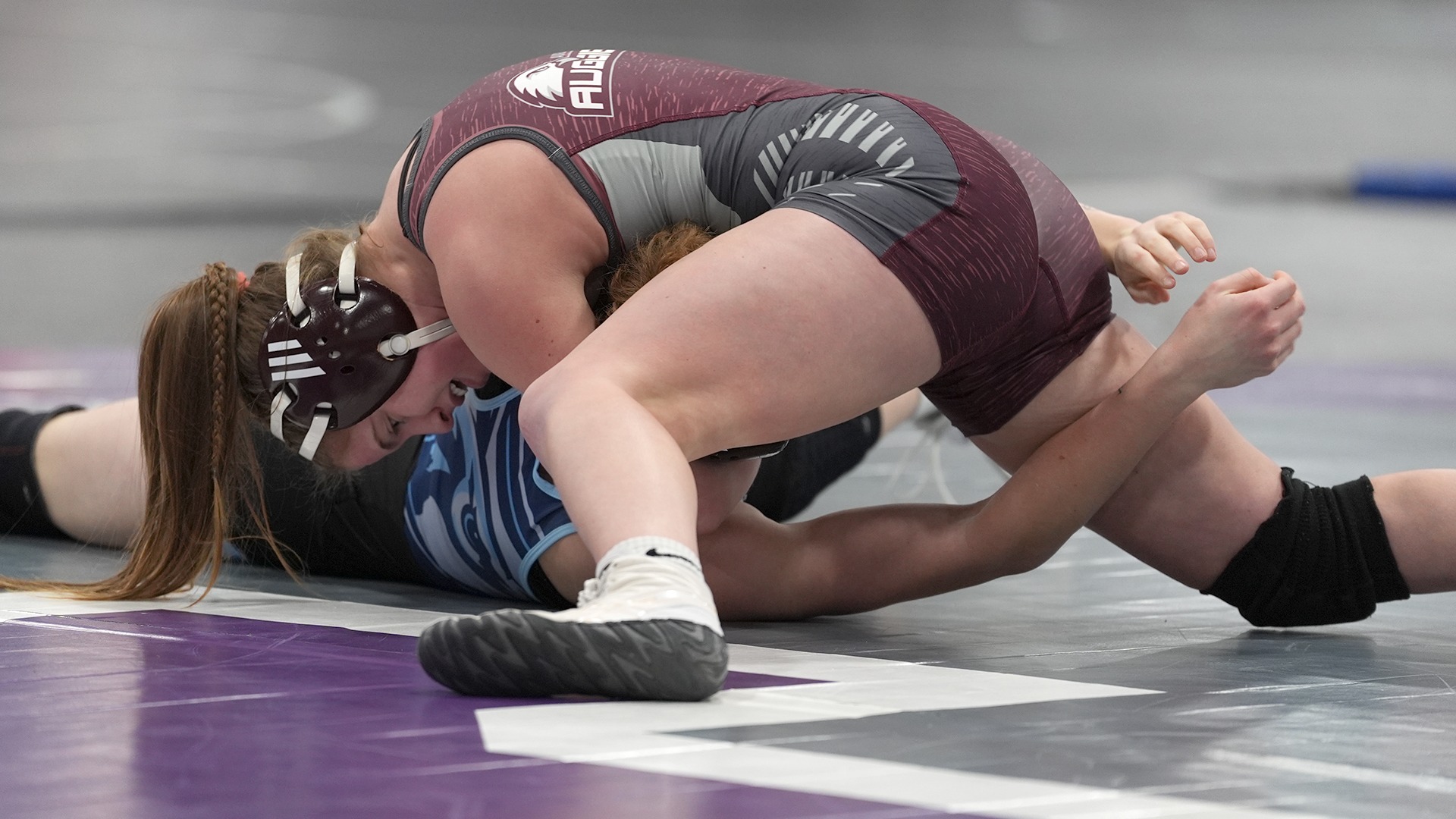 Paige Haaf pins an opponent during a 2025-26 Augsburg women's wrestling meet.